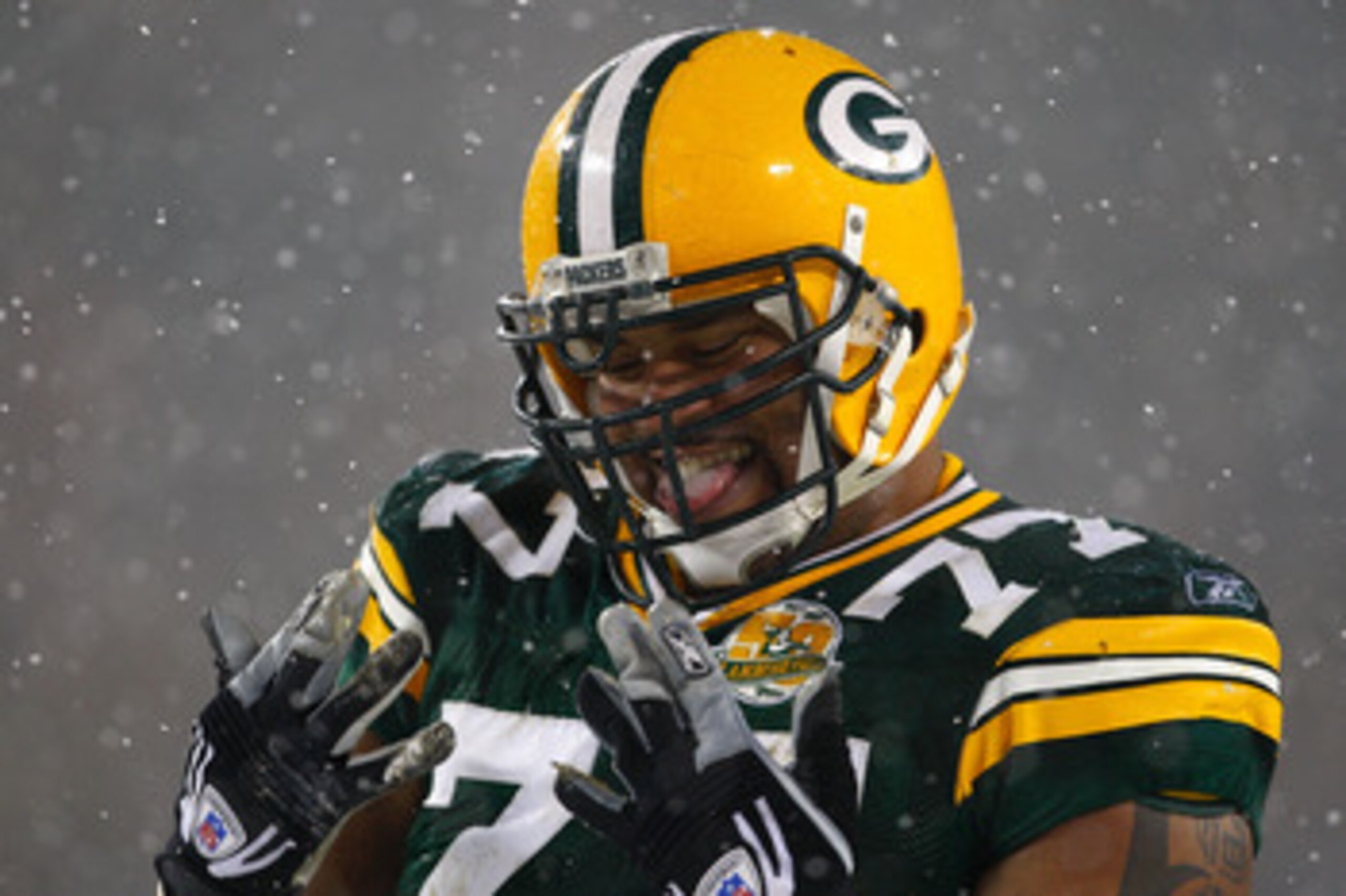 GREEN BAY, WI - JANUARY 12:  Defensive end Cullen Jenkins #77 of the Green Bay Packers smiles in the fourth quarter against the Seattle Seahawks during the NFC divisional playoff game on January 12, 2008 at Lambeau Field in Green Bay, Wisconsin.  (Photo b