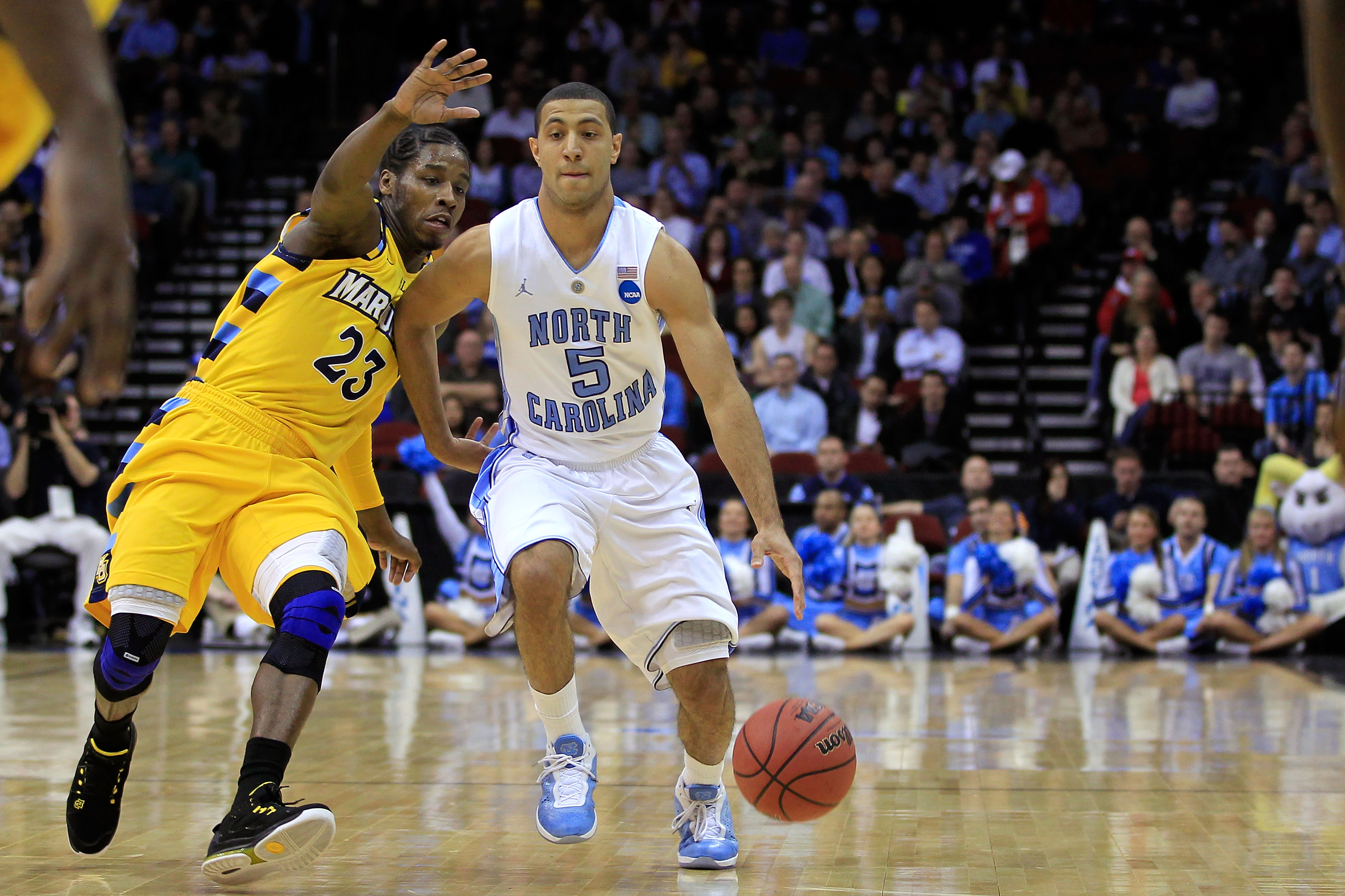 NEWARK, NJ - MARCH 25:  Kendall Marshall #5 of the North Carolina Tar Heels dribbles the ball against Junior Cadougan #5 of the Marquette Golden Eagles during the east regional semifinal of the 2011 NCAA Men's Basketball Tournament at the Prudential Cente