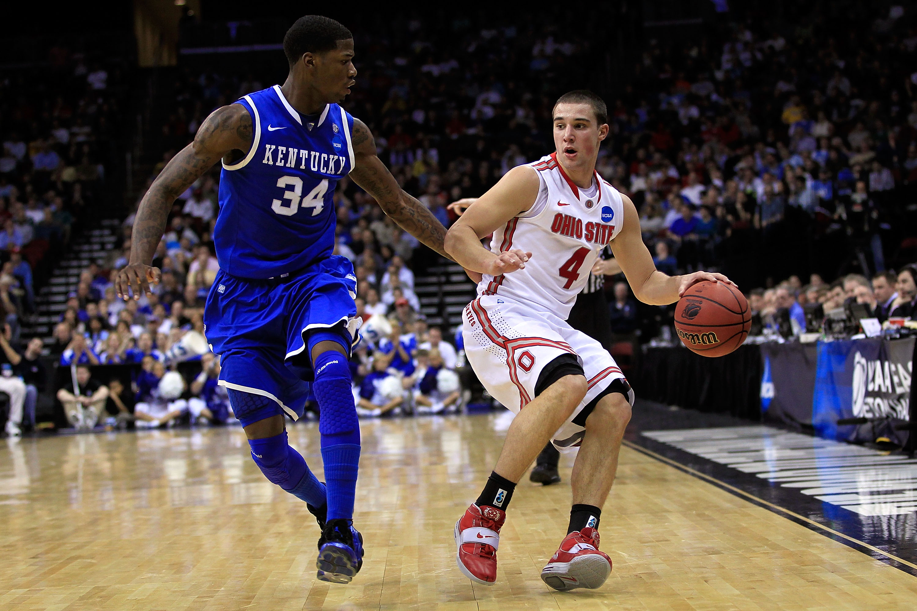 NEWARK, NJ - MARCH 25:  Aaron Craft #4 of the Ohio State Buckeyes brings the ball up court against DeAndre Liggins #34 of the Kentucky Wildcats during the east regional semifinal of the 2011 NCAA Men's Basketball Tournament at the Prudential Center on Mar