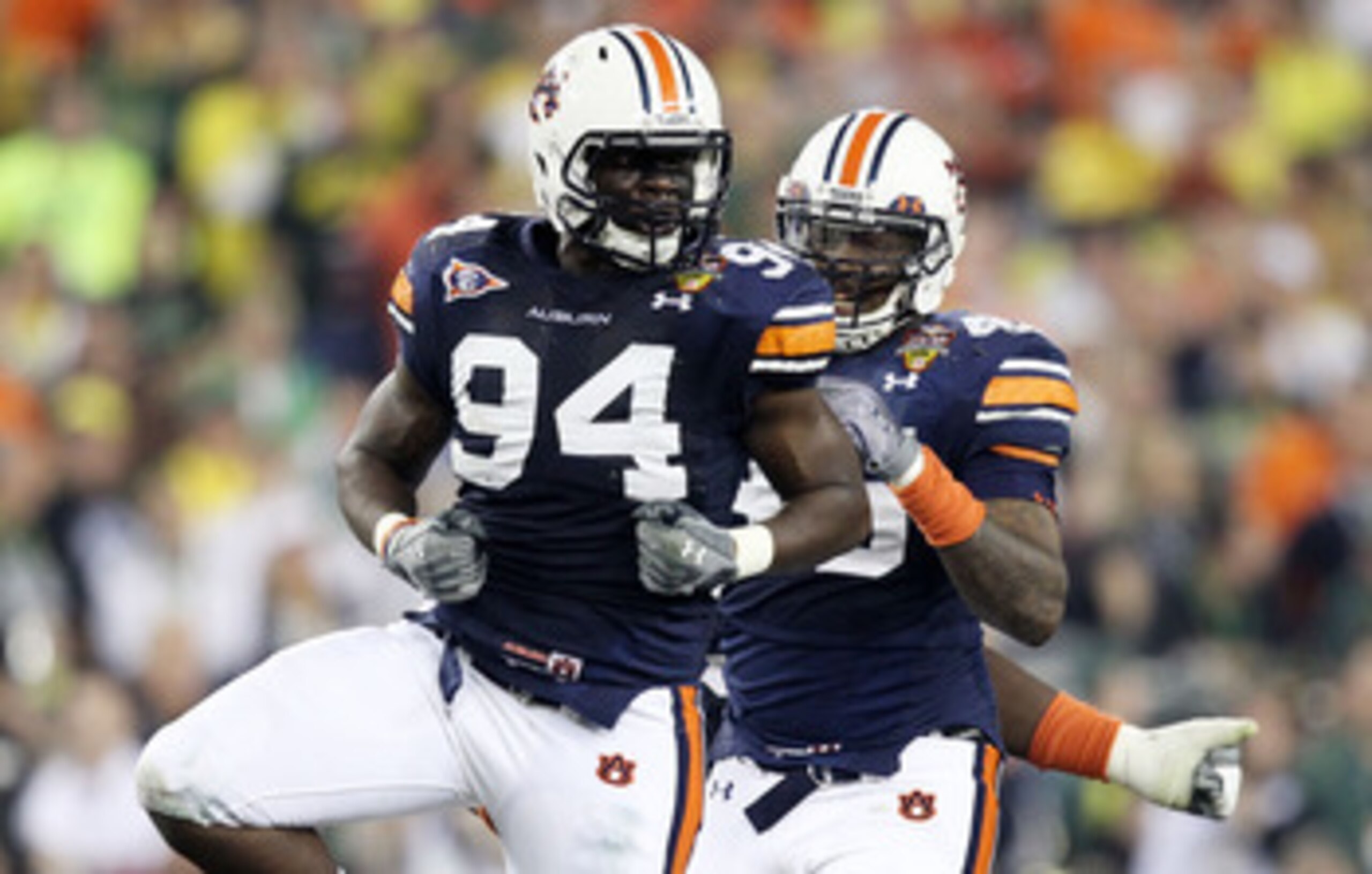 GLENDALE, AZ - JANUARY 10:  Nosa Eguae #94 and Antoine Carter #45 of the Auburn Tigers celebrate against the Oregon Ducks during the Tostitos BCS National Championship Game at University of Phoenix Stadium on January 10, 2011 in Glendale, Arizona.  (Photo