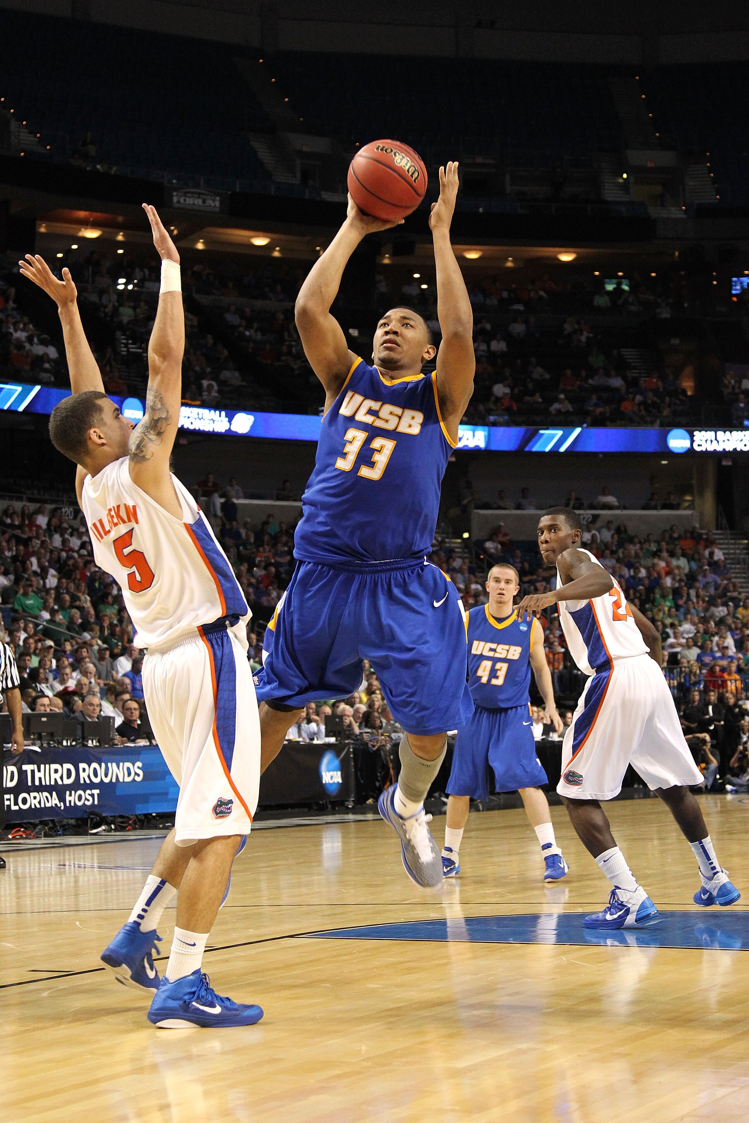 TAMPA, FL - MARCH 17:  Orlando Johnson #33 of the UC Santa Barbara Gauchos drives for a shot attempt against Scottie Wilbekin #5 of the Florida Gators during the second round of the 2011 NCAA men's basketball tournament at St. Pete Times Forum on March 17