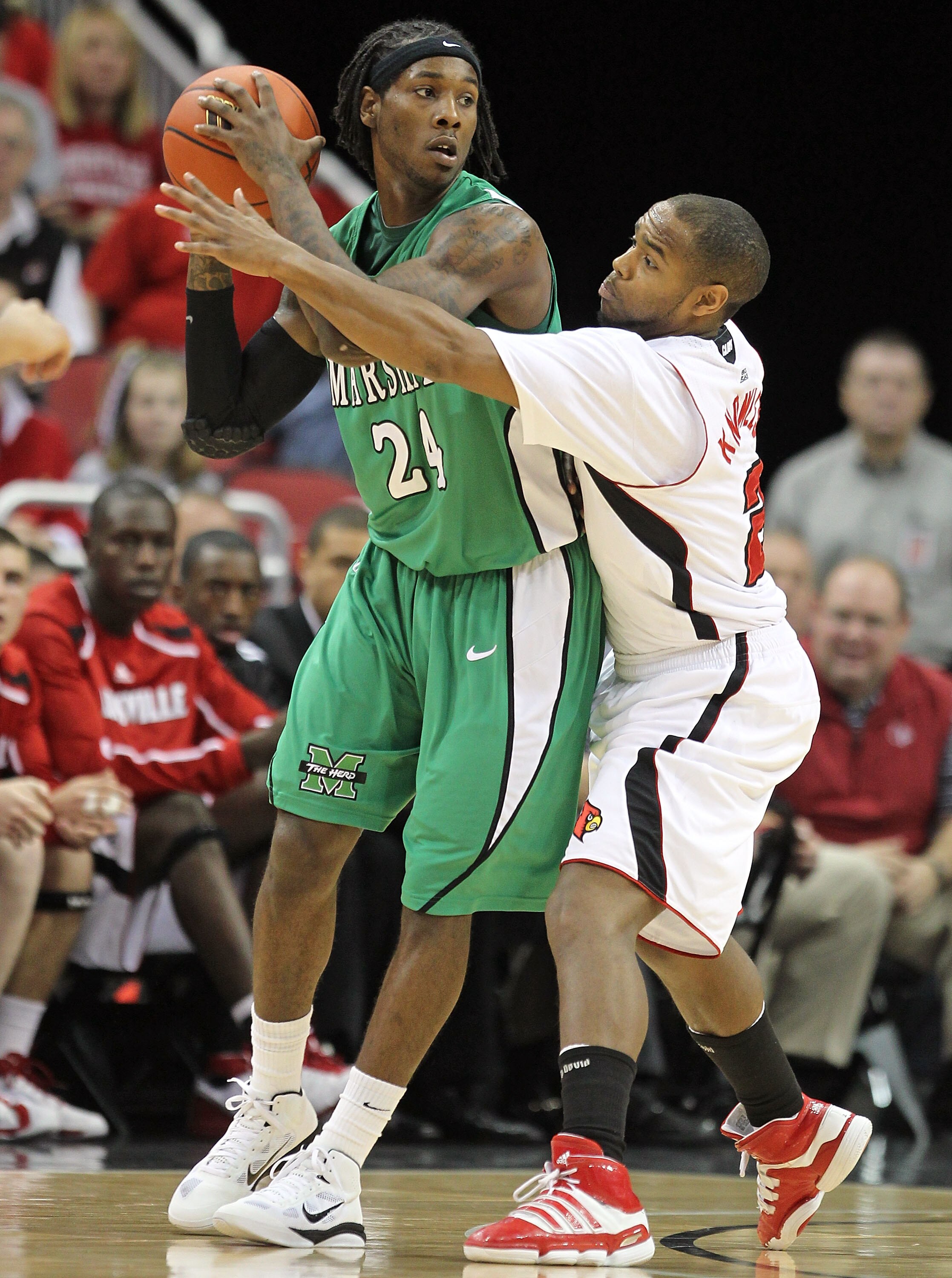 LOUISVILLE, KY - NOVEMBER 27: Preston Knowles #2 of the Louisville Cardinals defends DeAndre Kane #24 of the Marshall Thundering Herd during the game at the KFC Yum! Center on November 27, 2010 in Louisville, Kentucky.  Louisville won 80-66.  (Photo by An