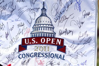 BETHESDA, MD - JUNE 13:  A fan holds an autographed flag during a practice round prior to the start of the 111th U.S. Open at Congressional Country Club on June 13, 2011 in Bethesda, Maryland.  (Photo by Andrew Redington/Getty Images)