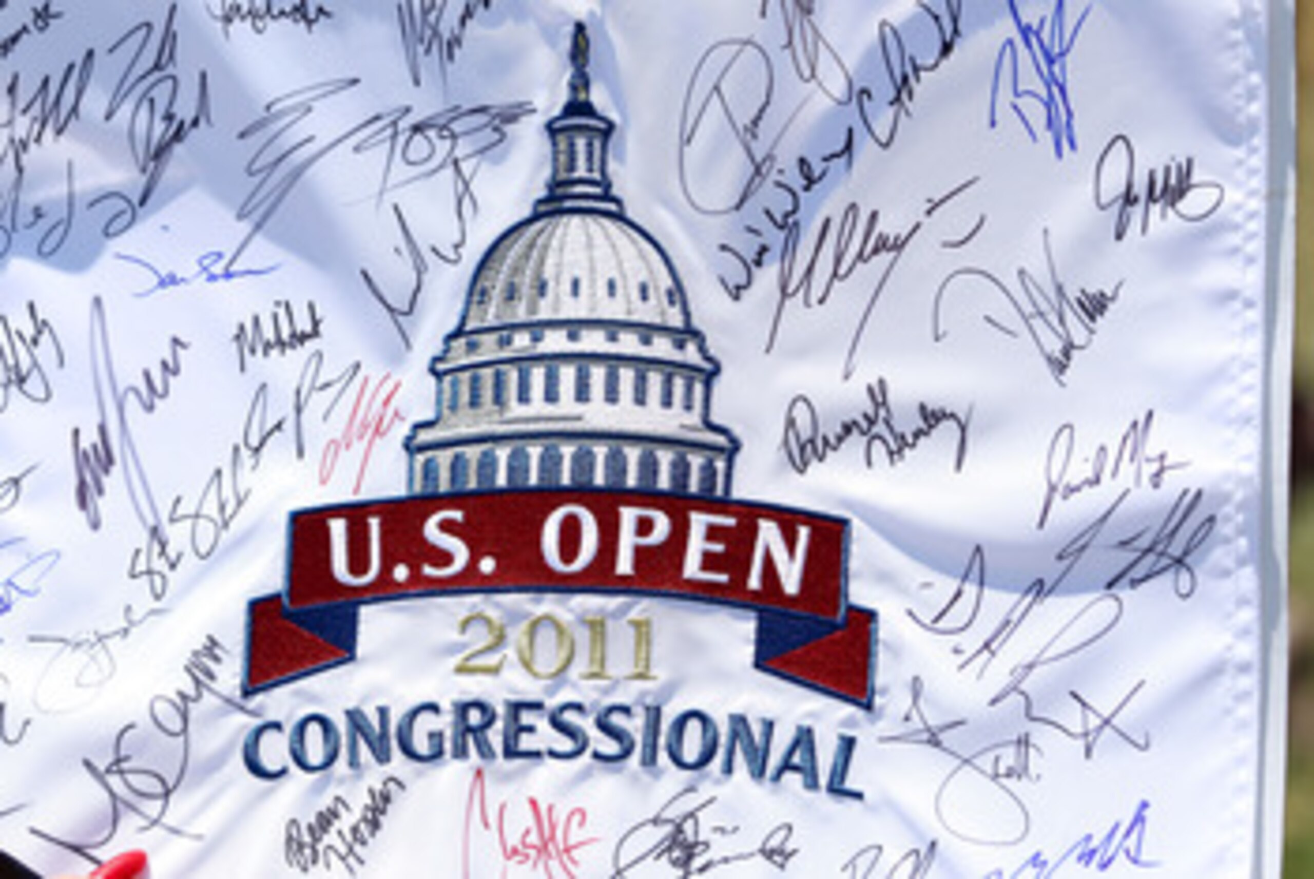 BETHESDA, MD - JUNE 13:  A fan holds an autographed flag during a practice round prior to the start of the 111th U.S. Open at Congressional Country Club on June 13, 2011 in Bethesda, Maryland.  (Photo by Andrew Redington/Getty Images)