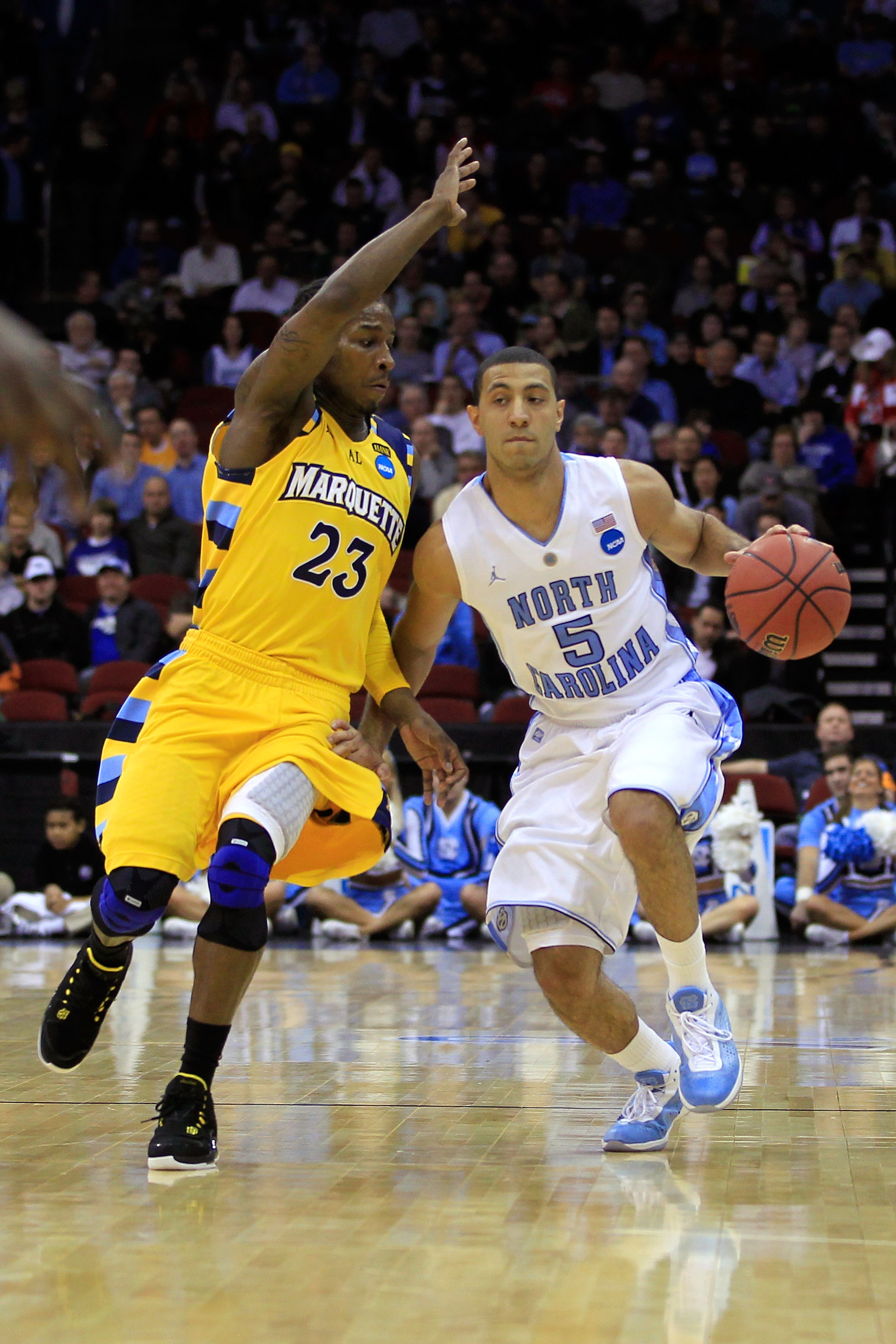 NEWARK, NJ - MARCH 25:  Kendall Marshall #5 of the North Carolina Tar Heels dribbles the ball against Dwight Buycks #23  of the Marquette Golden Eagles during the east regional semifinal of the 2011 NCAA Men's Basketball Tournament at the Prudential Cente