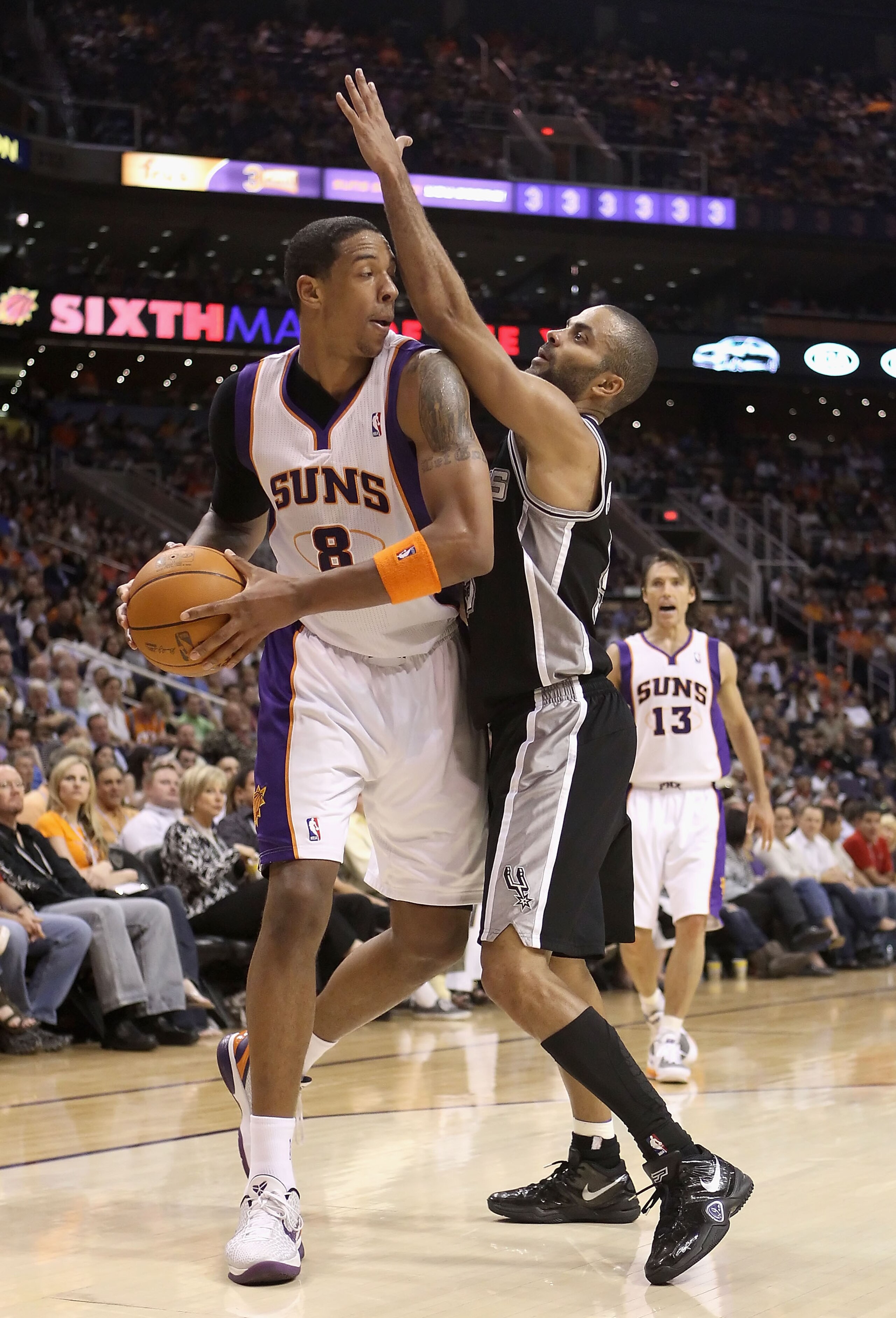 PHOENIX, AZ - APRIL 13:  Channing Frye #8 of the Phoenix Suns handles the ball under pressure from Tony Parker #9 of the San Antonio Spurs during the NBA game at US Airways Center on April 13, 2011 in Phoenix, Arizona.  NOTE TO USER: User expressly acknow