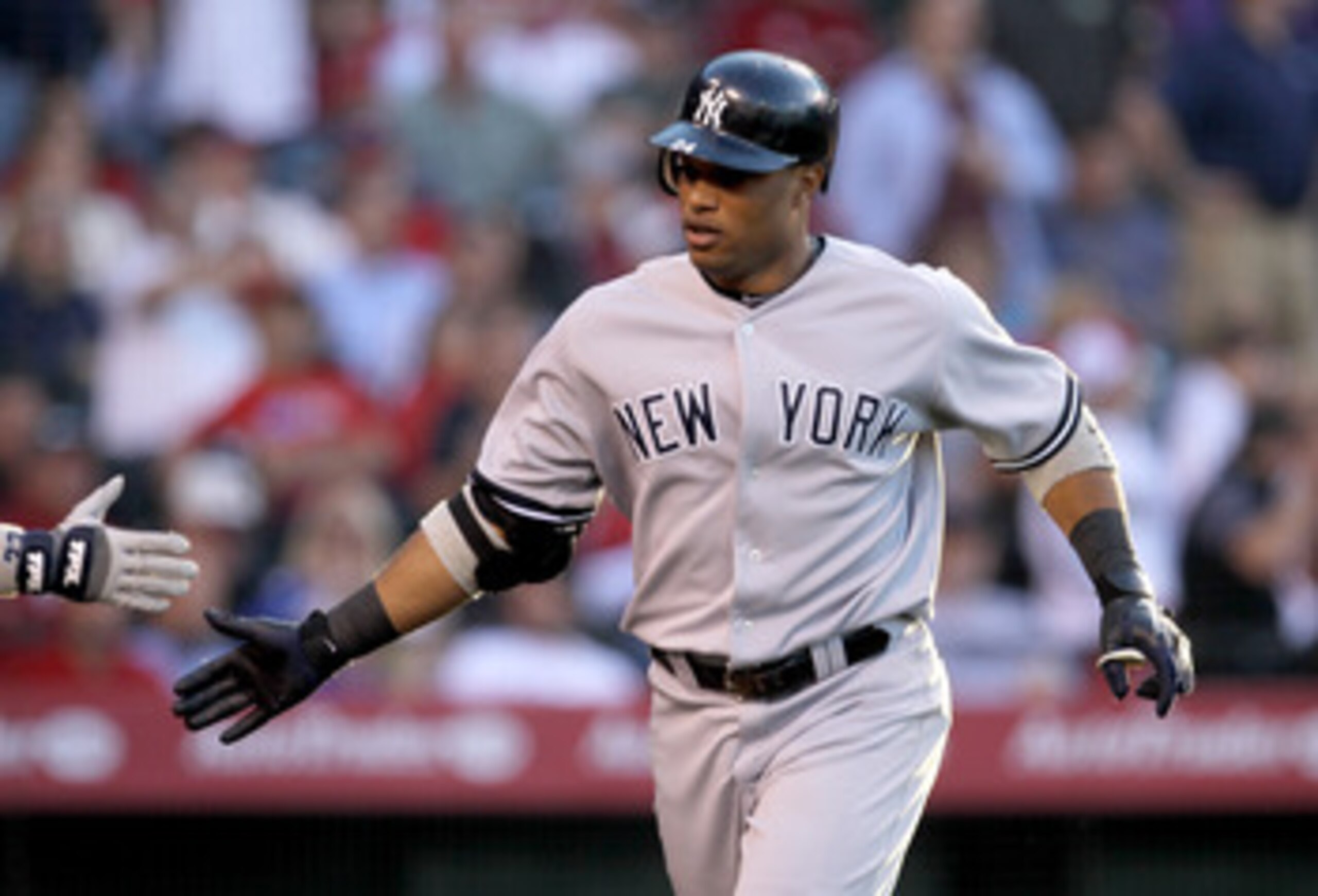 ANAHEIM, CA - JUNE 4:  Robinson Cano #24 of the New York Yankees celebrates as he returns to the dugout after hitting a home run in thhe fourth inning against the Los Angeles Angels of Anaheim on June 4, 2011 at Angel Stadium in Anaheim, California.   (Ph