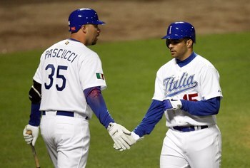 KISSIMMEE, FL - MARCH 07:  Center fielder Vincent Sinisi #15 of Italy is congratulated by Valentino Pascucci #35 at home plate after Sinisi hit a home run in the sixth inning of the first round of the World Baseball Classic on March 7, 2006 at The Ballpar