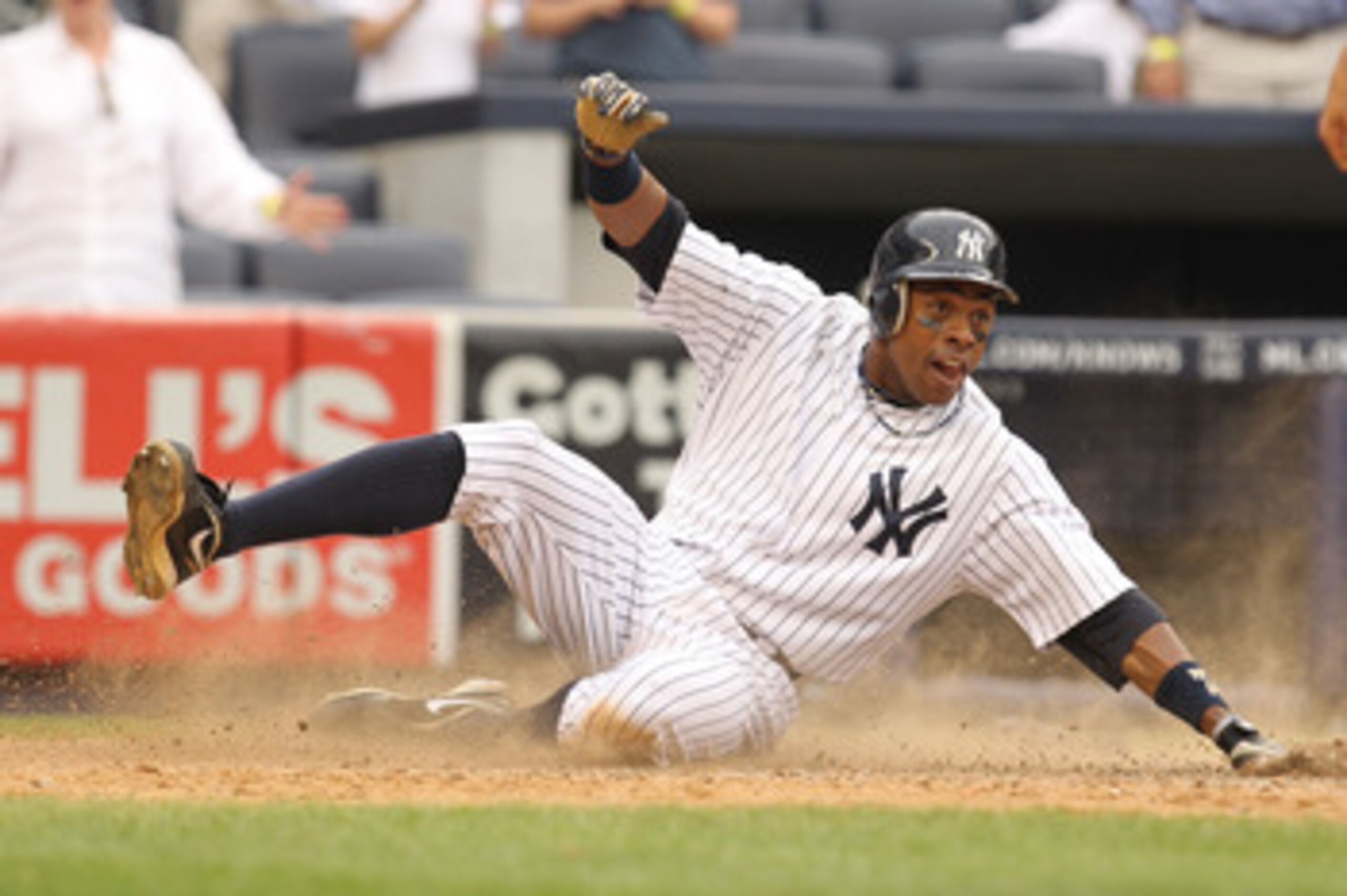 NEW YORK, NY - JUNE 16:  Curtis Granderson #14 of the New York Yankees scores the game winning run from a hit a by Brett Gardner #11 against the Texas Rangers  in the twelfth inning during their game on June 16, 2011 at Yankee Stadium in the Bronx borough