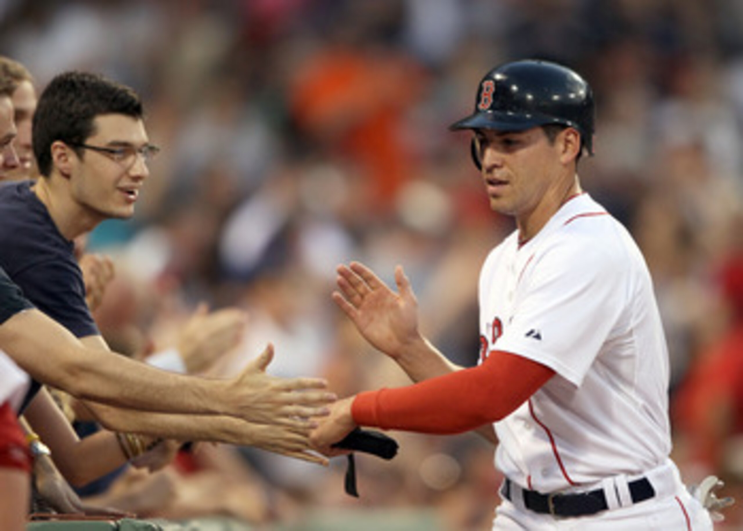 BOSTON, MA - MAY 30:  Jacoby Ellsbury #2 of the Boston Red Sox celebrates with fans after he scored in the third innng against the Chicago White Sox on May 30, 2011 at Fenway Park in Boston, Massachusetts.  (Photo by Elsa/Getty Images)