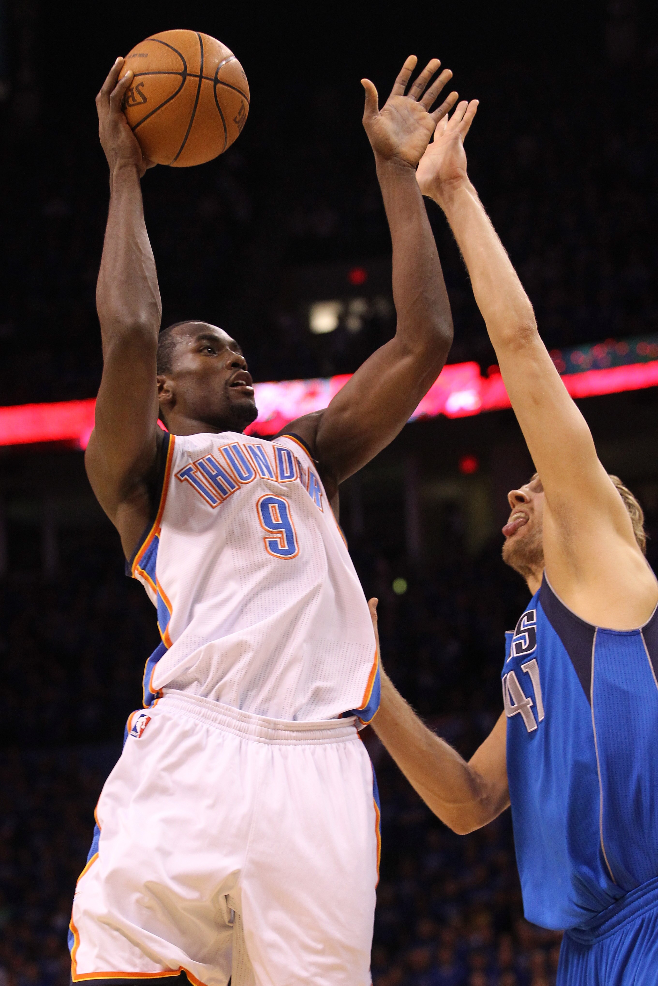 OKLAHOMA CITY, OK - MAY 23:  Serge Ibaka #9 of the Oklahoma City Thunder shoots over Dirk Nowitzki #41 of the Dallas Mavericks in the first quarter in Game Four of the Western Conference Finals during the 2011 NBA Playoffs at Oklahoma City Arena on May 23