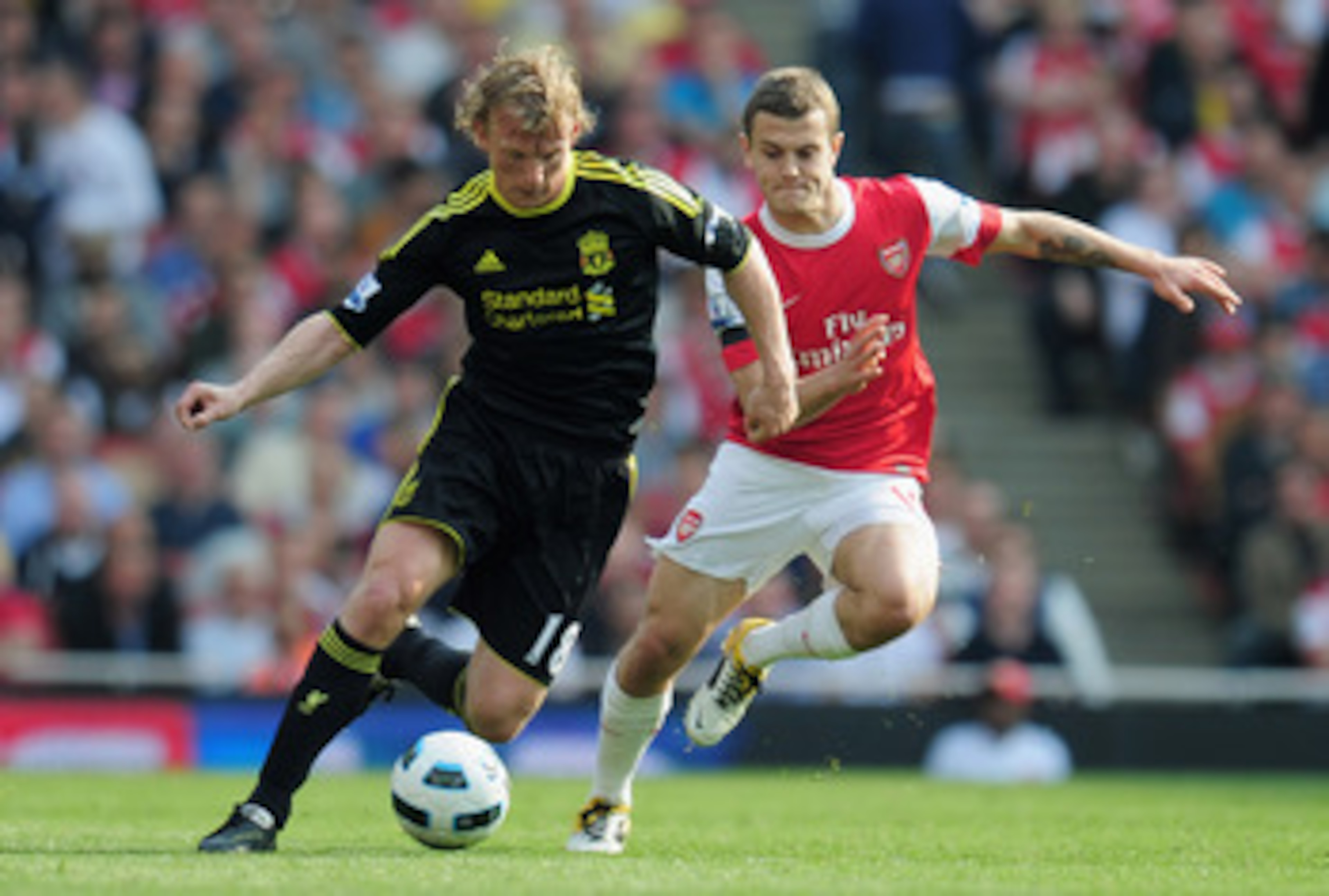 LONDON, ENGLAND - APRIL 17:  Dirk Kuyt of Liverpool is closed down by Jack Wilshere of Arsenal during the Barclays Premier League match between Arsenal and Liverpool at the Emirates Stadium on April 17, 2011 in London, England.  (Photo by Shaun Botterill/