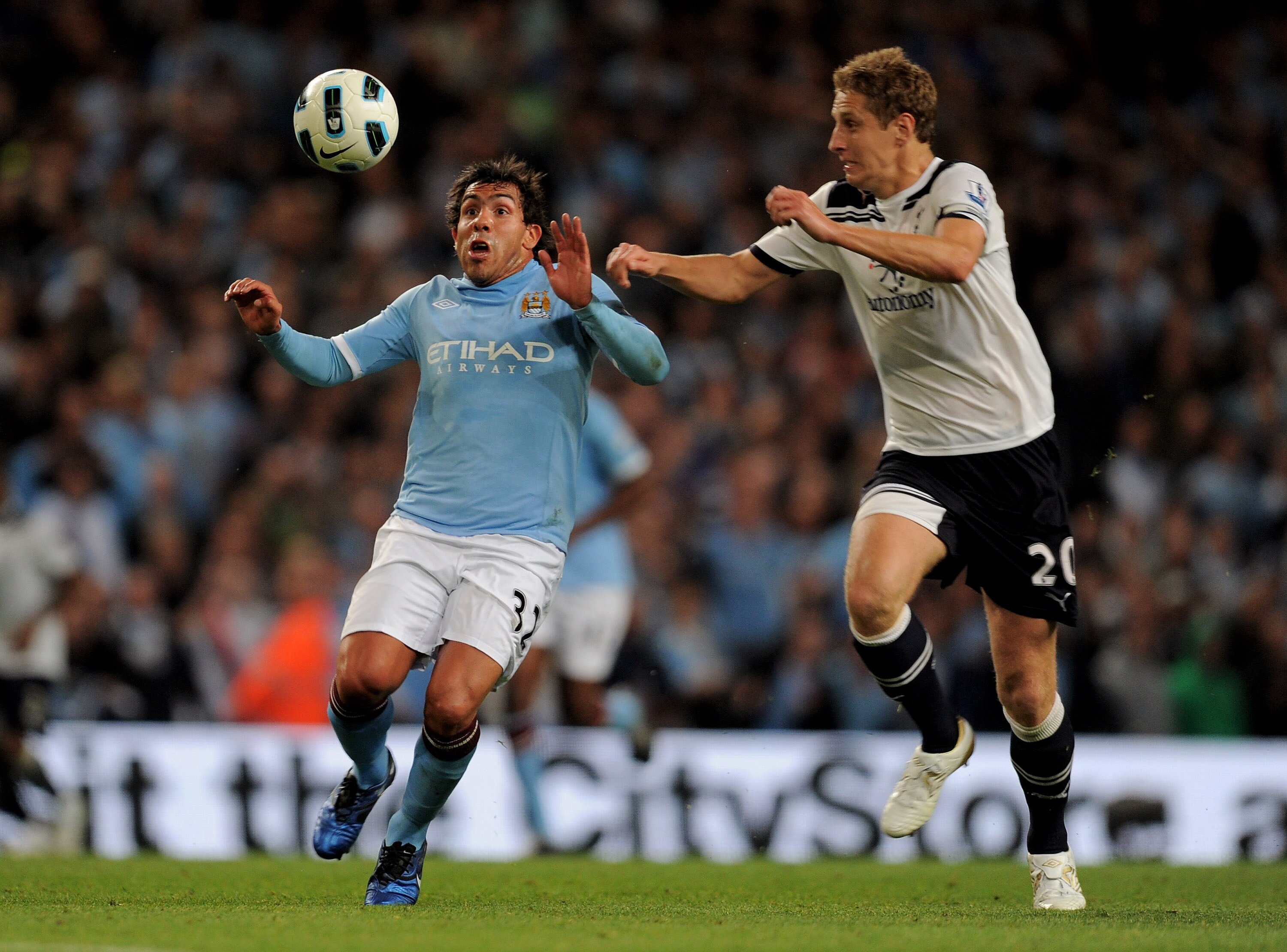 MANCHESTER, ENGLAND - MAY 10:  Carlos Tevez of Manchester City competes with Michael Dawson of Tottenham Hotspur during the Barclays Premier League match between Manchester City and Tottenham Hotspur at the City of Manchester Stadium on May 10, 2011 in Ma