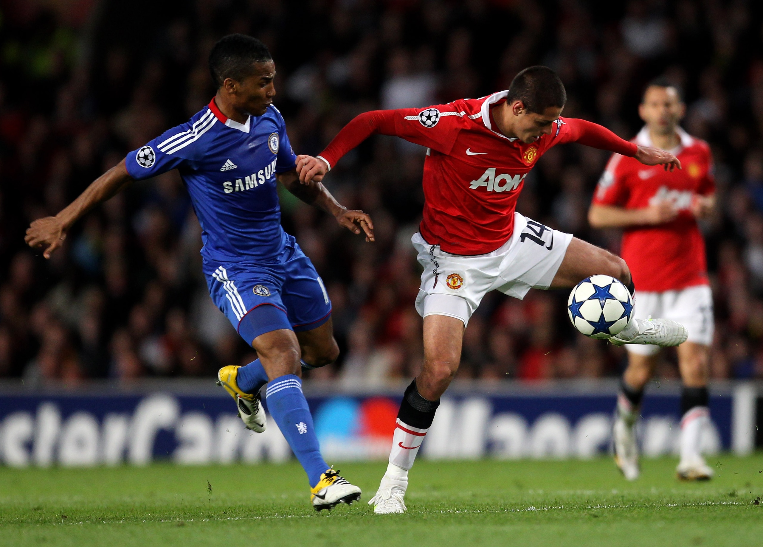 MANCHESTER, ENGLAND - APRIL 12:  Javier Hernandez of Manchester United competes with Florent Malouda of Chelsea during the UEFA Champions League Quarter Final second leg match between Manchester United and Chelsea at Old Trafford on April 12, 2011 in Manc