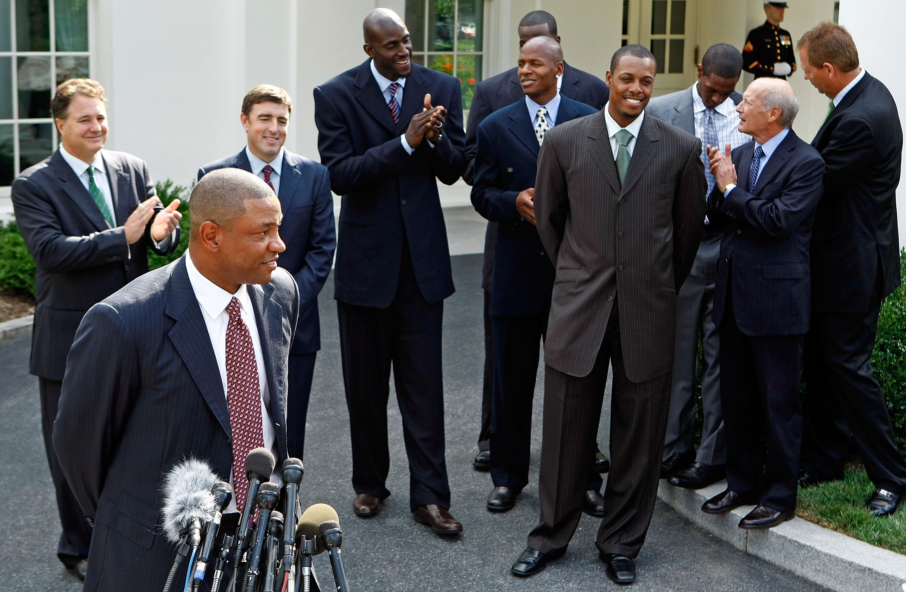 WASHINGTON - SEPTEMBER 19:  Boston Celtic head coach Doc Rivers (front L) talks to reporters outside the West Wing with (L-R) with team managing partner Steve Pagliuca, team co-owner Wycliffe 'Wyc' Grousbeck, players Kevin Garnett, Ray Allen, Paul Pierce,