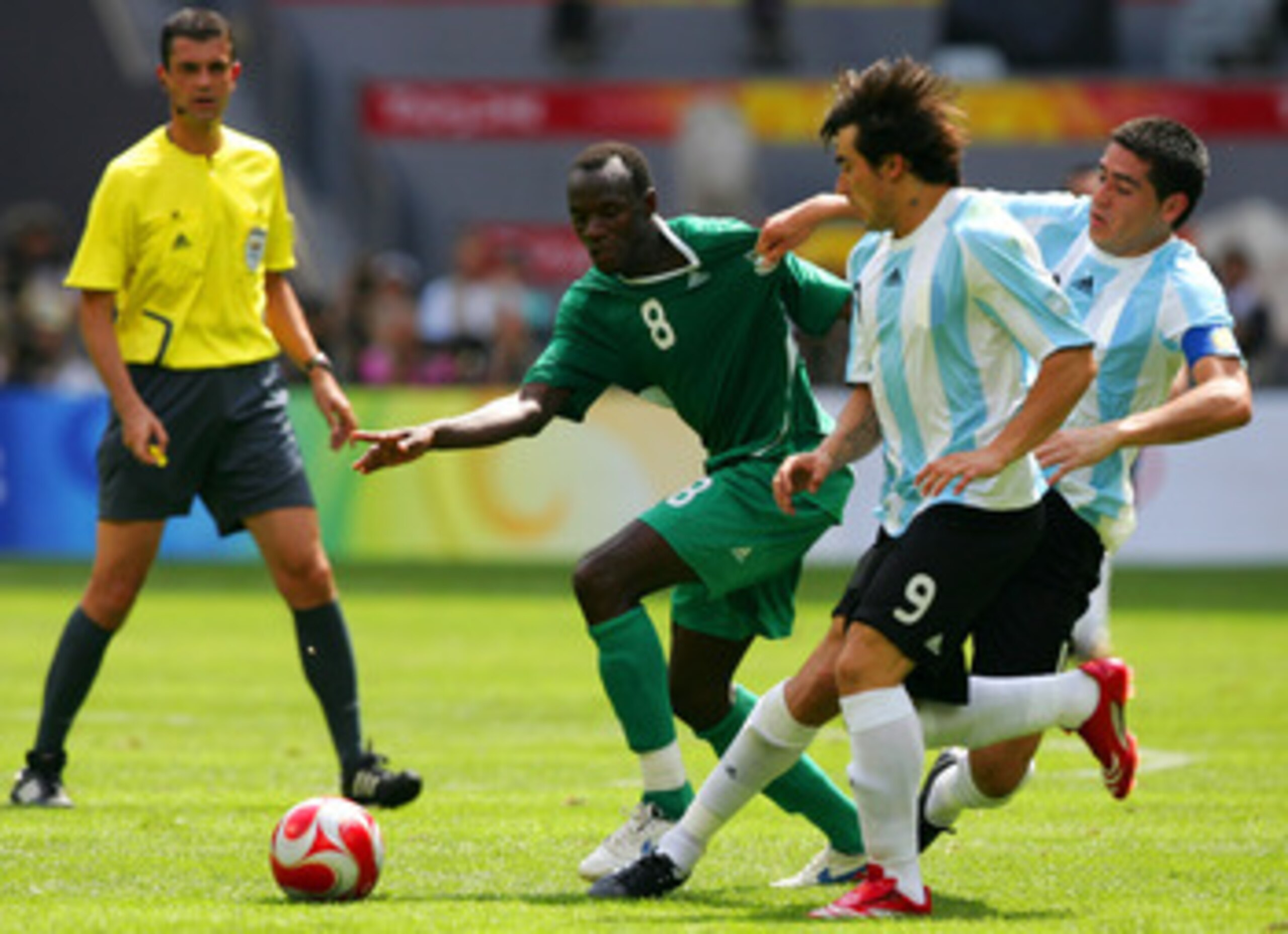 BEIJING - AUGUST 23: Sani Kaita of Nigeria and  Juan Riquelme of Argentina compete for the ball during the Men's Final between Nigeria and Argentina at the National Stadium on Day 15 of the Beijing 2008 Olympic Games on August 23, 2008 in Beijing, China.