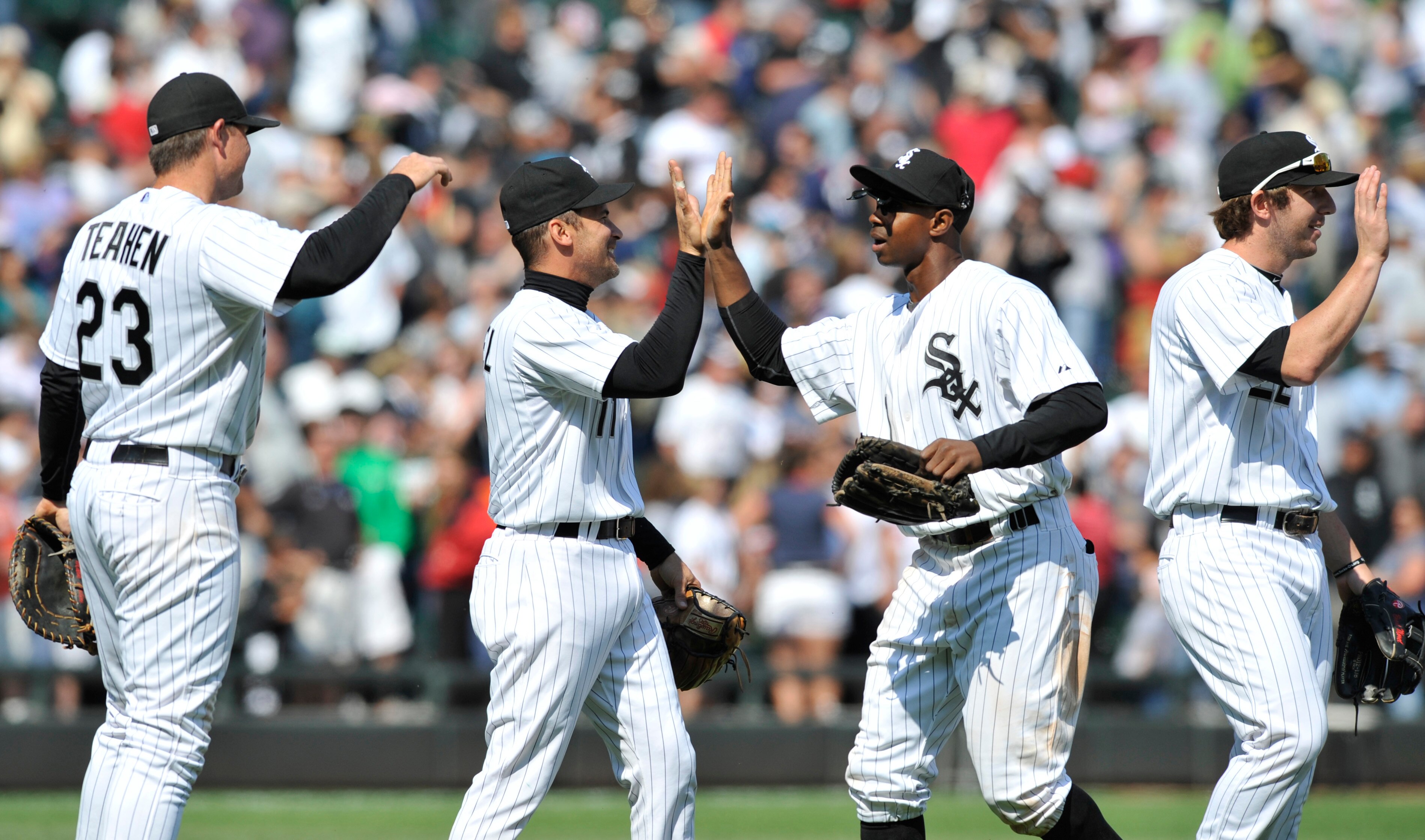 CHICAGO, IL - JUNE 12: L-R  Mark Teahen #23, Omar Vizquel #11, Juan Pierre #1, and Brent Morel #22 of the Chicago White Sox celebrate their victory against the Oakland Athletics on June 12, 2011 at U.S. Cellular Field in Chicago, Illinois. The White Sox d