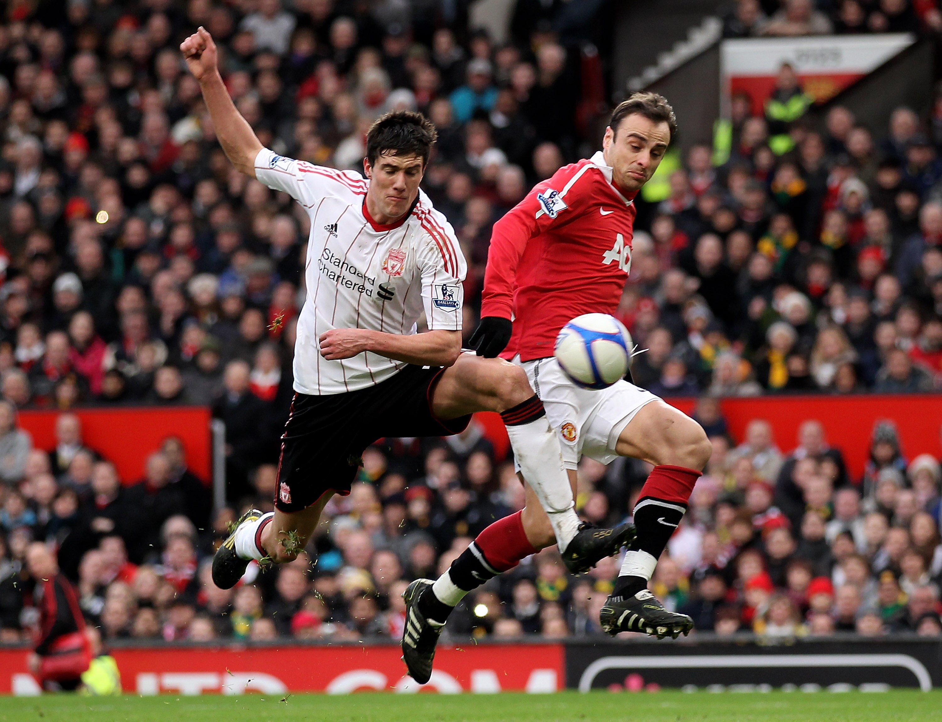 MANCHESTER, ENGLAND - JANUARY 09:  Martin Kelly of Liverpool challenges Dimitar Berbatov of Manchester United during the FA Cup sponsored by E.ON 3rd round match between Manchester United and Liverpool at Old Trafford on January 9, 2011 in Manchester, Eng