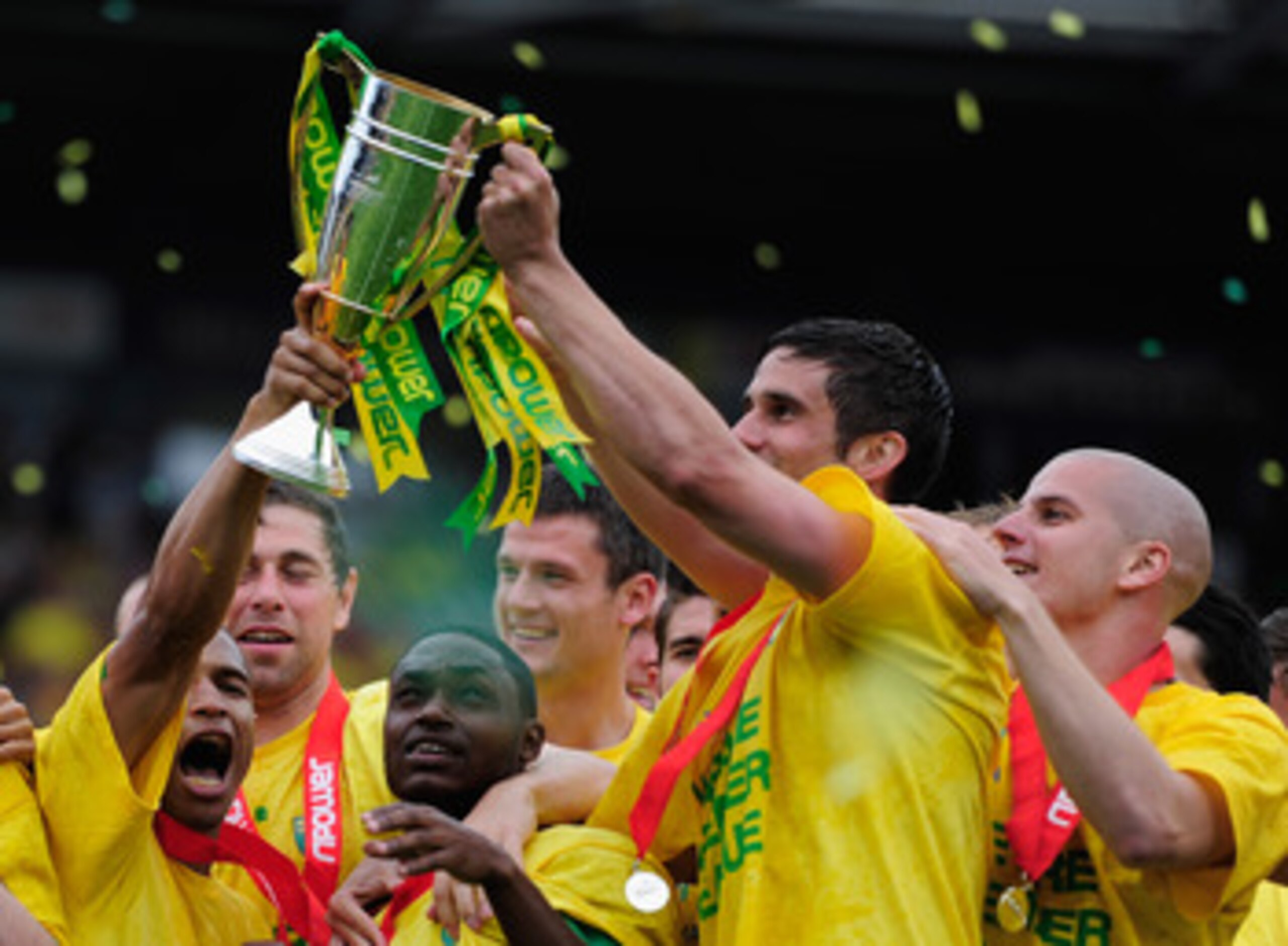 NORWICH, ENGLAND - MAY 07: Norwich City players celebrate promotion during the npower Championship match between Norwich City and Coventry City at Carrow Road on May 7, 2011 in Norwich, England. (Photo by Jamie McDonald/Getty Images) NORWICH, ENGLAND - MAY 07: Norwich City players celebrate promotion during the npower Championship match between Norwich City and Coventry City at Carrow Road on May 7, 2011 in Norwich, England. (Photo by Jamie McDonald/Getty Images)