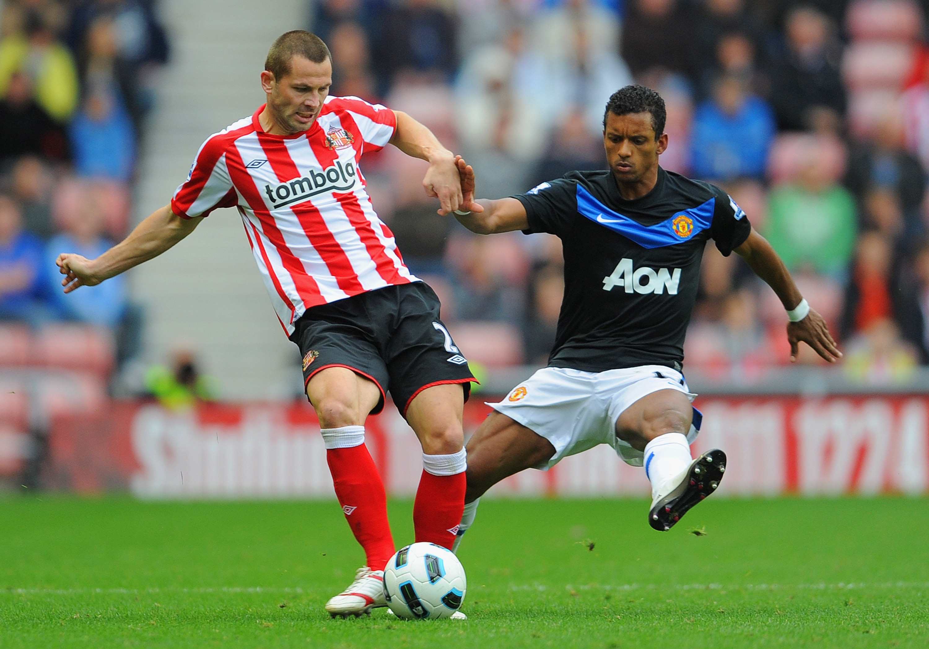 SUNDERLAND, ENGLAND - OCTOBER 02:  Nani of Manchester United pressures Phil Bardsley of Sunderland during the Barclays Premier League match between Sunderland and Manchester United at the Stadium of Light on October 2, 2010 in Sunderland, England.  (Photo