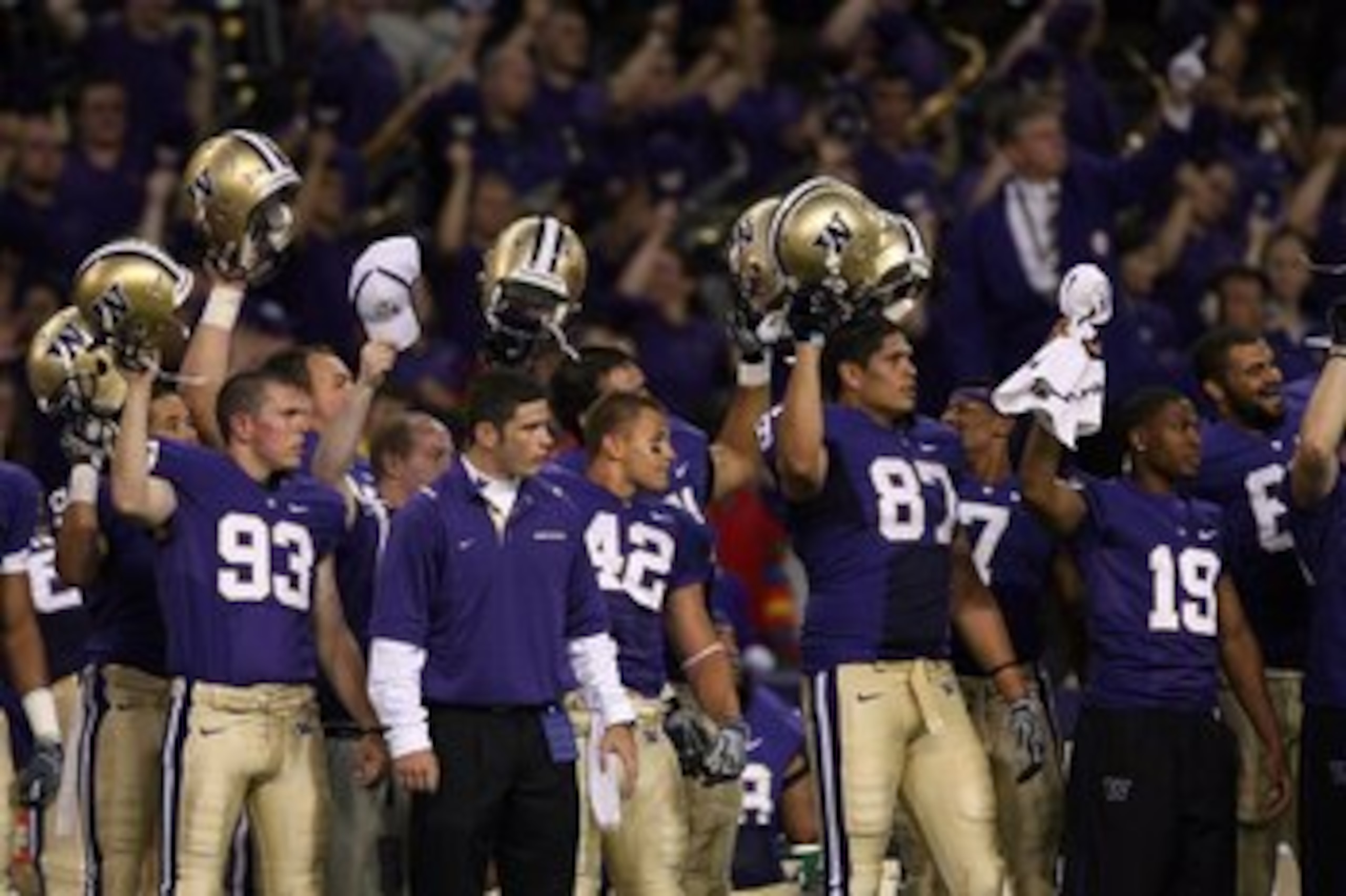 SEATTLE - SEPTEMBER 5:  Members of the Washington Huskies football team stand on the sideline raising their helmets during the game against the LSU Tigers on September 5, 2009 at Husky Stadium in Seattle, Washington. The LSU Tigers defeated the Washington