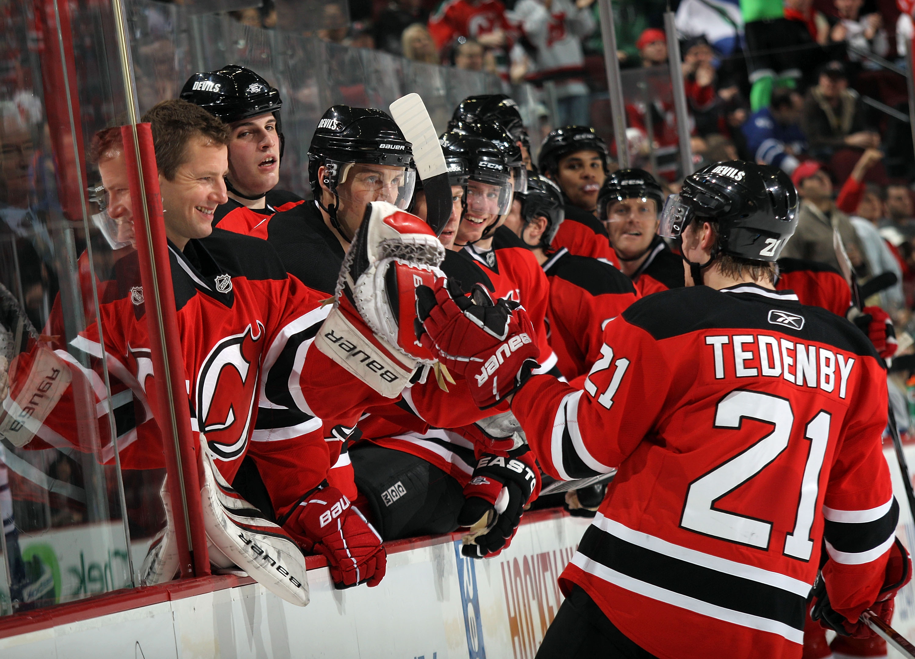 NEWARK, NJ - APRIL 06: Johan Hedberg #1 of the New Jersey Devils celebrates a goal by Mattias Tedenby #21 against the Toronto Maple Leafs at the Prudential Center on April 6, 2011 in Newark, New Jersey.  (Photo by Bruce Bennett/Getty Images)