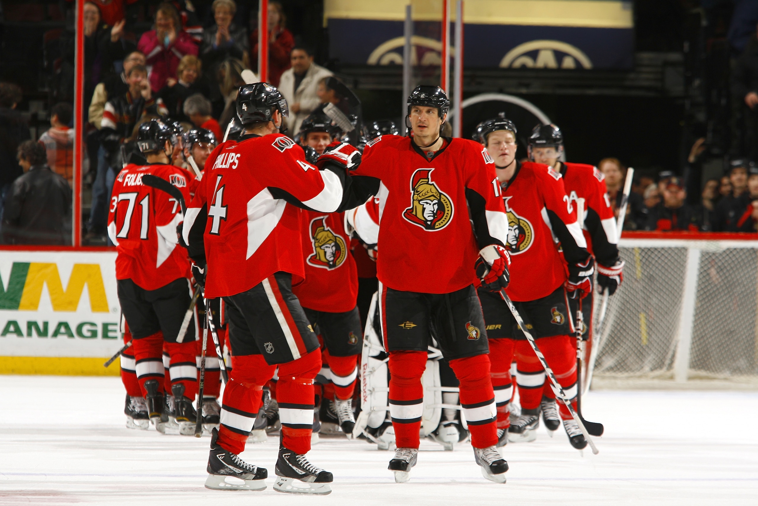 OTTAWA, CANADA - APRIL 07:  Chris Phillips #4 of the Ottawa Senators high-fives teammate Filip Kuba #17 after a victory over the Montreal Canadiens at Scotiabank Place on April 7, 2011 in Ottawa, Canada.  (Photo by Phillip MacCallum/Getty Images)
