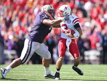 SEATTLE - SEPTEMBER 18: Quarterback Taylor Martinez #3 of the Nebraska Cornhuskers is tackled by Alameda Ta'amu #74 of the Washington Huskies on September 18, 2010 at Husky Stadium in Seattle, Washington. (Photo by Otto Greule Jr/Getty Images)