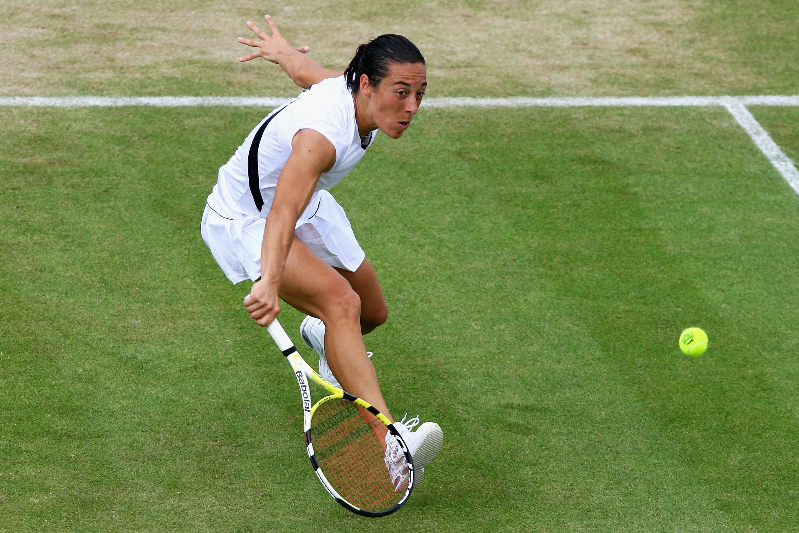 WIMBLEDON, ENGLAND - JUNE 29:  Francesca Schiavone of Italy plays a backhand during the women's singles fourth round match against Virginie Razzano of France on Day Seven of the Wimbledon Lawn Tennis Championships at the All England Lawn Tennis and Croque