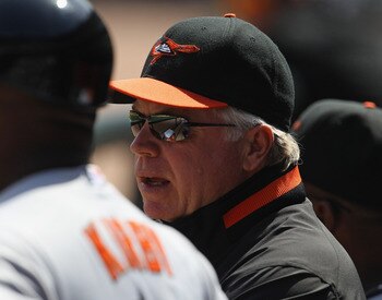 CHICAGO, IL - MAY 01: Manager Buck Showalter #26 of the Baltimore Orioles talks in the dugout with assistant coaches during a game against the Chicago White Sox at U.S. Cellular Field on May 1, 2011 in Chicago, Illinois. The Orioles defeated the White Sox