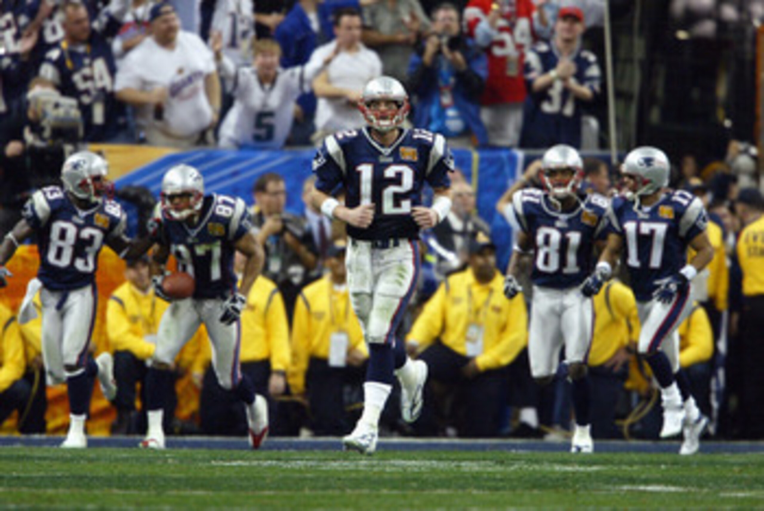 HOUSTON - FEBRUARY 1:  Quarterback Tom Brady #12 of the New England Patriots, center, leads his teammates back onto the field for second half action against the Carolina Panthers during Super Bowl XXXVIII at Reliant Stadium on February 1, 2004 in Houston,