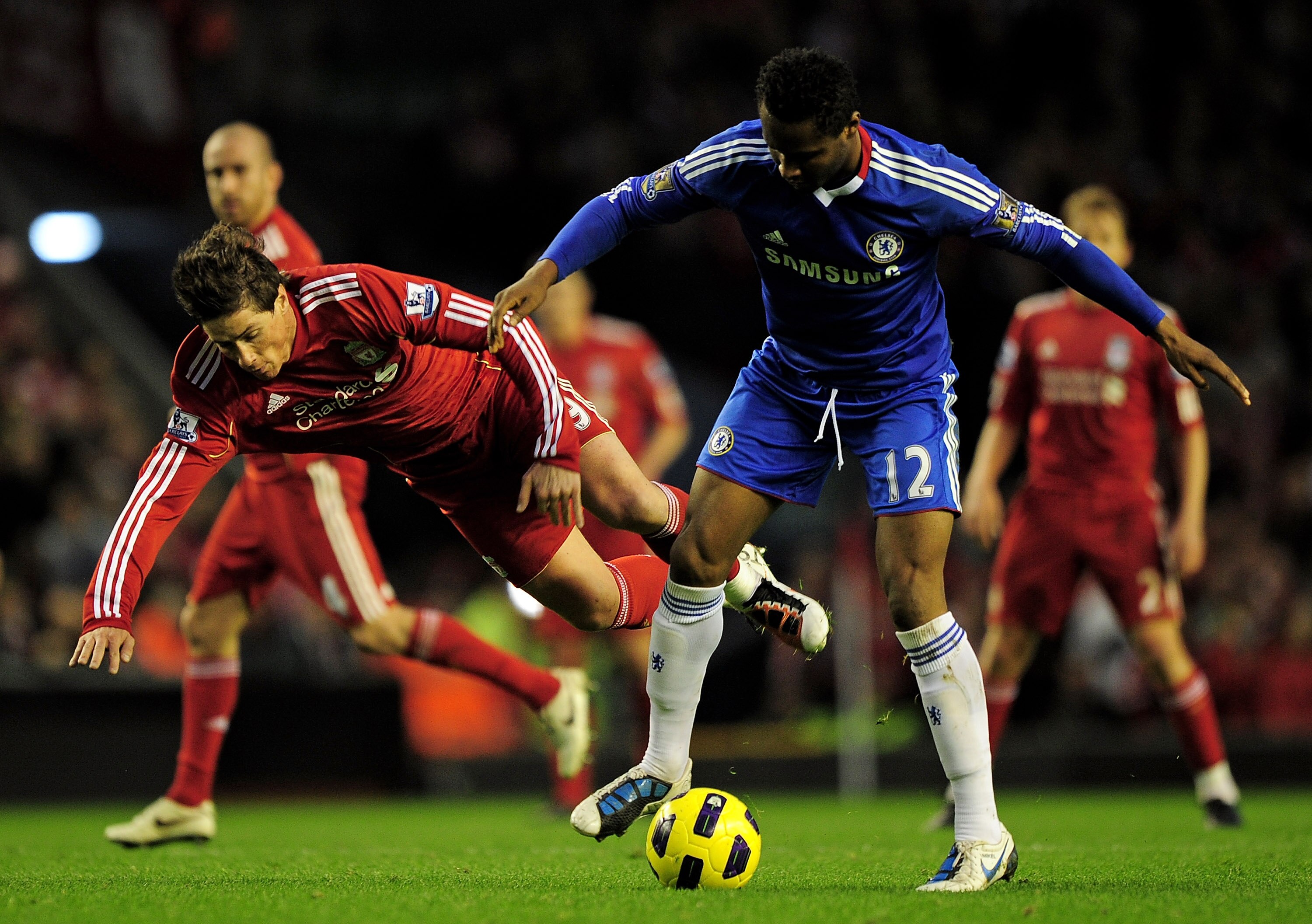 LIVERPOOL, ENGLAND - NOVEMBER 07:   Fernando Torres of Liverpool tangles with John Obi Mikel of Chelsea during the Barclays Premier League match between Liverpool and Chelsea at Anfield on November 7, 2010 in Liverpool, England. (Photo by Shaun Botterill/