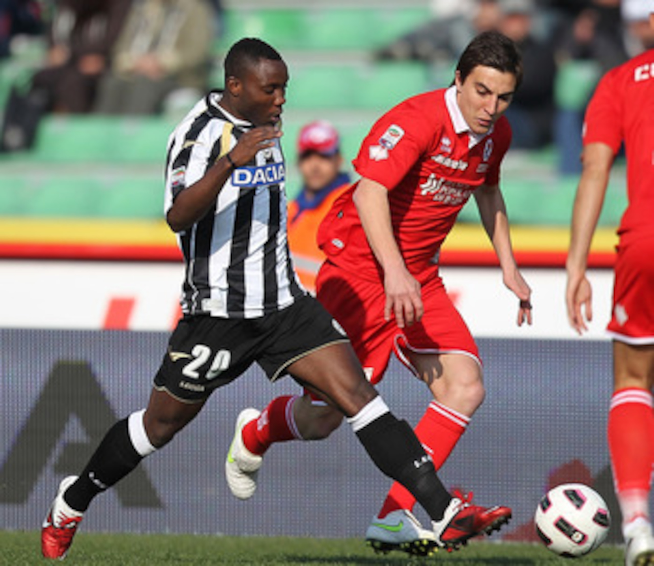 UDINE, ITALY - MARCH 06: Kwadwo Asamoah (L) of Udinese Calcio fights for the ball with Nicola Bentivoglio of AS Bari during the Serie A match between Udinese Calcio and AS Bari at Stadio Friuli on March 6, 2011 in Udine, Italy. (Photo by Gabriele Maltint UDINE, ITALY - MARCH 06: Kwadwo Asamoah (L) of Udinese Calcio fights for the ball with Nicola Bentivoglio of AS Bari during the Serie A match between Udinese Calcio and AS Bari at Stadio Friuli on March 6, 2011 in Udine, Italy. (Photo by Gabriele Maltint
