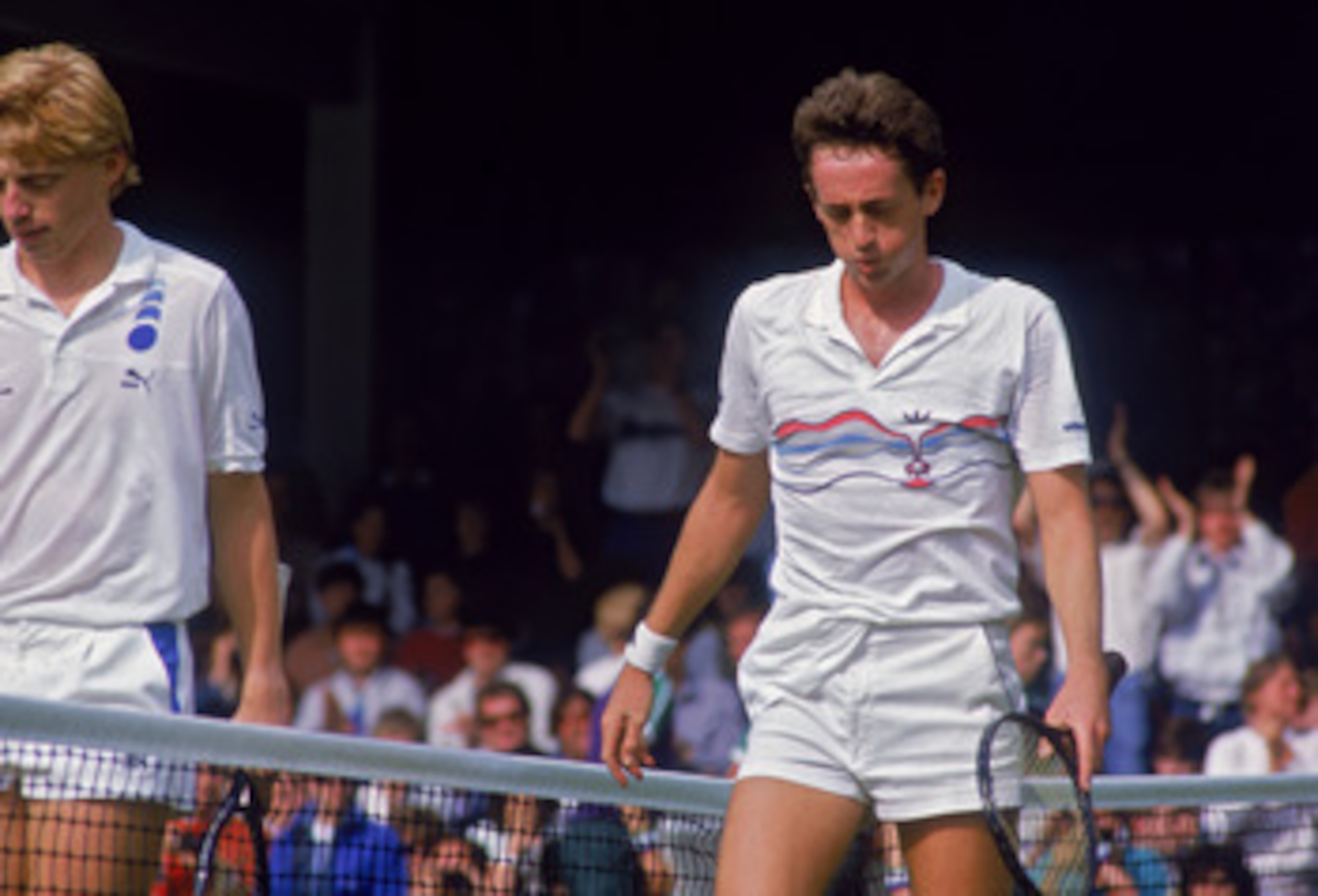 Defending champion Boris Becker of West Germany (left) and unseeded Australian tennis player Peter Doohan during their second-round match in the Championships at Wimbledon, London, 26th June 1987. Doohan eventually defeated the top-seeded player, 7-6, 4-6