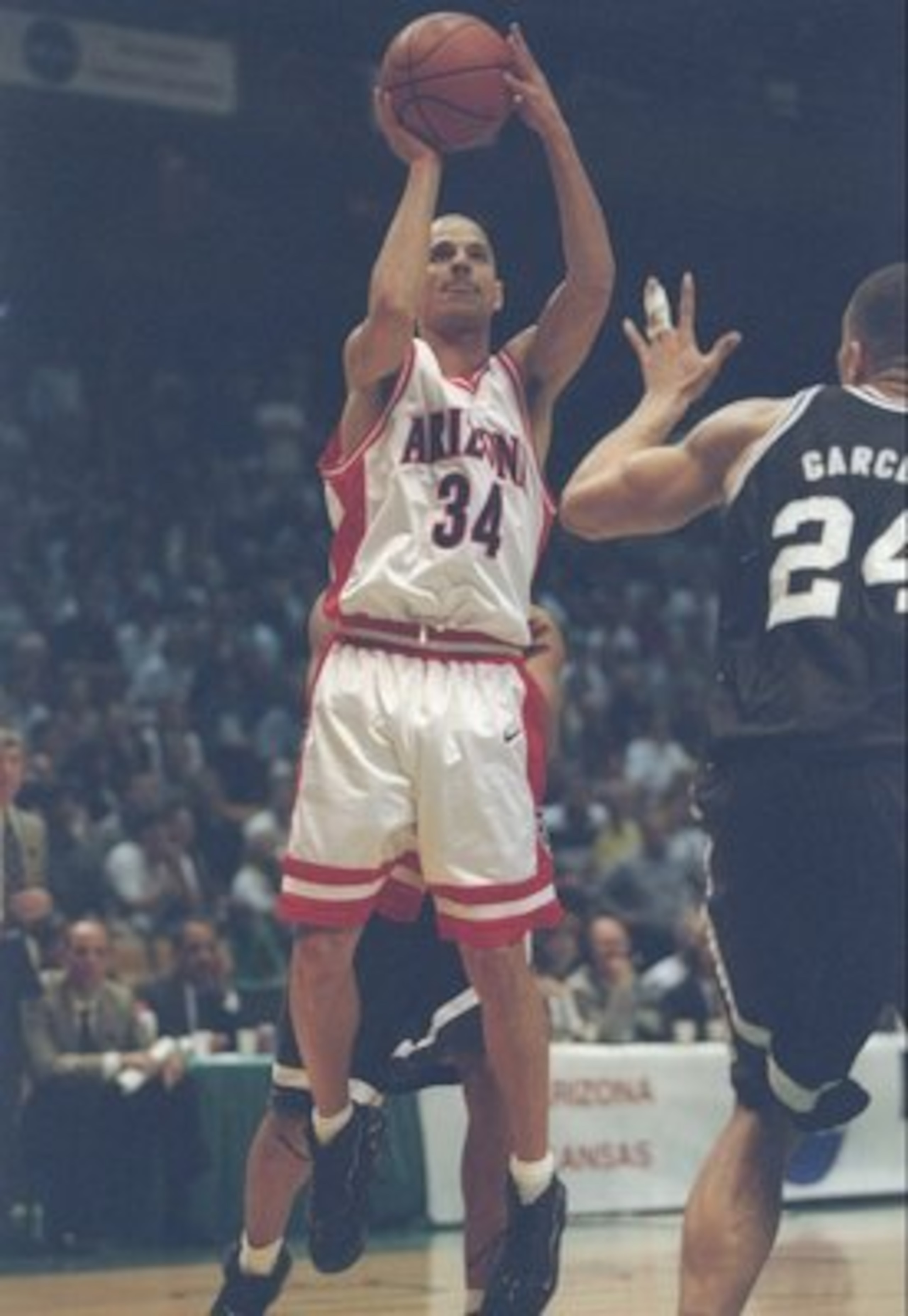 23 Mar 1997: Guard Miles Simon of the Arizona Wildcats shoots the ball over center Ruben Garces of the Providence Friars during a playoff game at the Birmingham-Jefferson Civic Center in Birmingham, Alabama. Arizona won the game 96 - 92. Mandatory Credi 23 Mar 1997: Guard Miles Simon of the Arizona Wildcats shoots the ball over center Ruben Garces of the Providence Friars during a playoff game at the Birmingham-Jefferson Civic Center in Birmingham, Alabama. Arizona won the game 96 - 92. Mandatory Credi