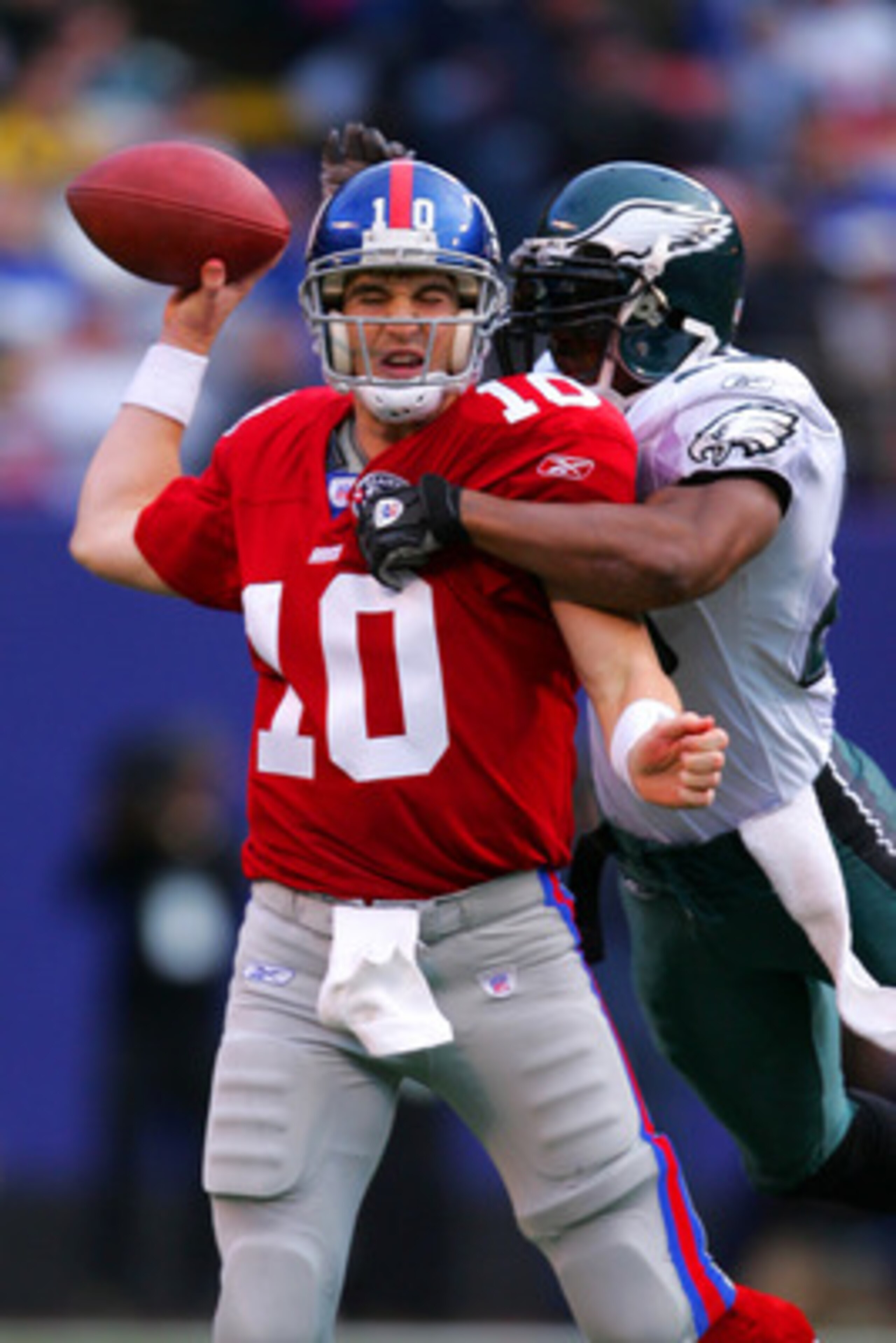 EAST RUTHERFORD, NJ - NOVEMBER 28: Quarterback Eli Manning #10 of the New York Giants is sacked by Brian Dawkins #20 of the Philadelphia Eagles at Giants Stadium on November 28, 2004 in East Rutherford, New Jersey. The Eagles defeated the Giants 27-6. (Ph