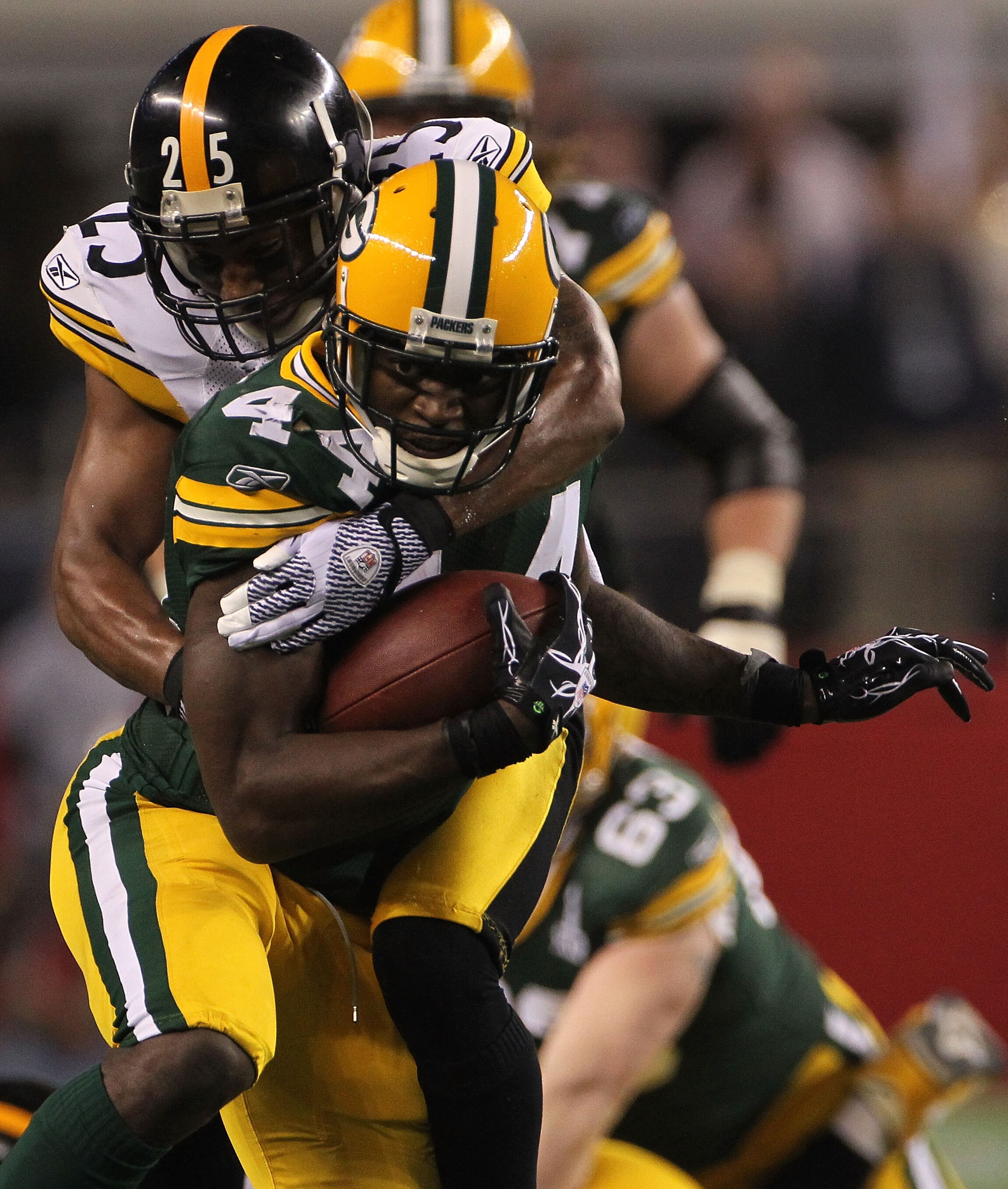 ARLINGTON, TX - FEBRUARY 06:  James Starks #44 of the Green Bay Packers runs the ball as he is tackled from behind by Ryan Clark #25 of the Pittsburgh Steelers during Super Bowl XLV at Cowboys Stadium on February 6, 2011 in Arlington, Texas.  (Photo by Do