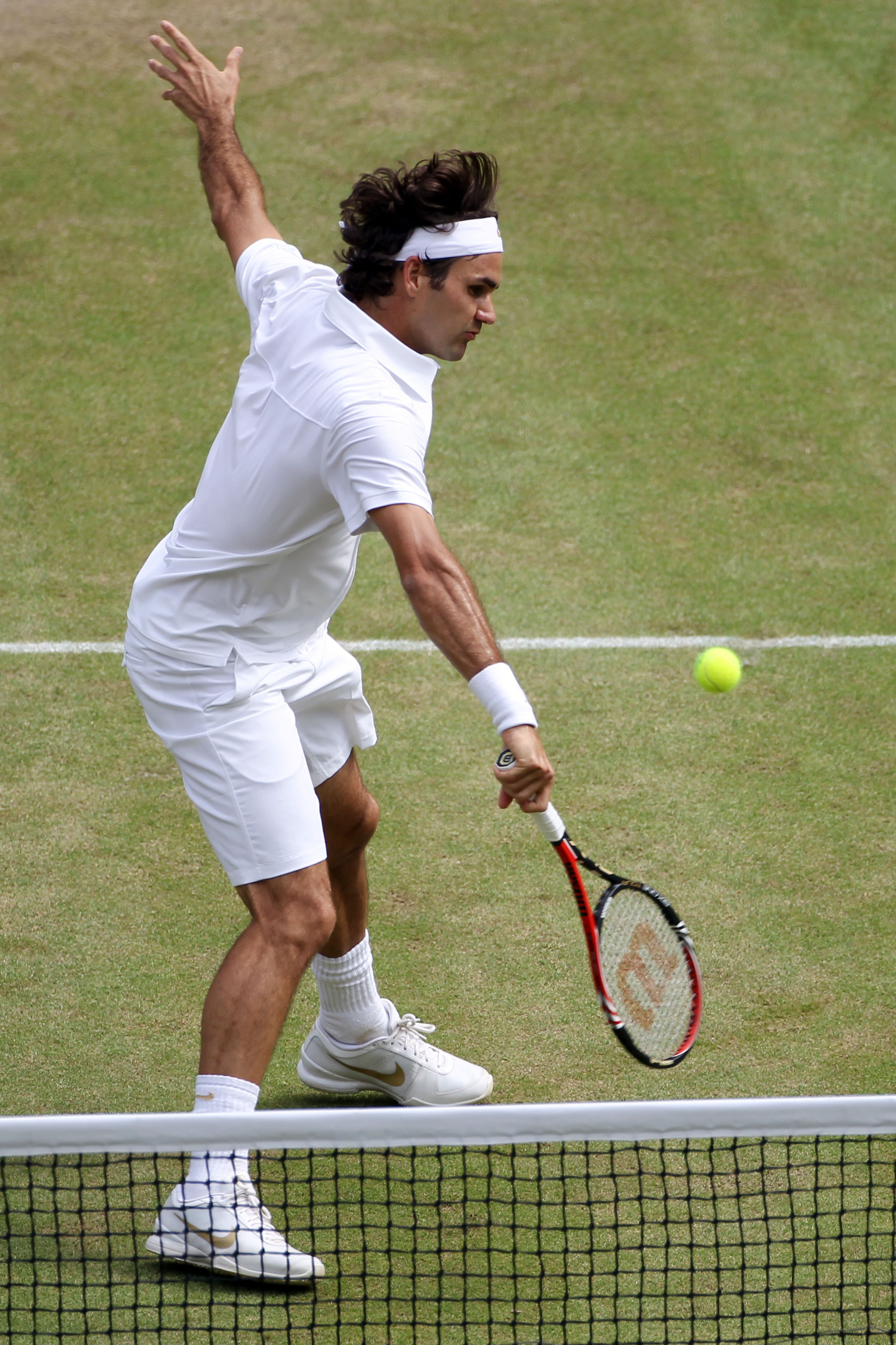 LONDON, ENGLAND - JUNE 30:  Roger Federer of Switzerland returns a shot during his Quarter Final match against Tomas Berdych of Czech Republic on Day Nine of the Wimbledon Lawn Tennis Championships at the All England Lawn Tennis and Croquet Club on June 3