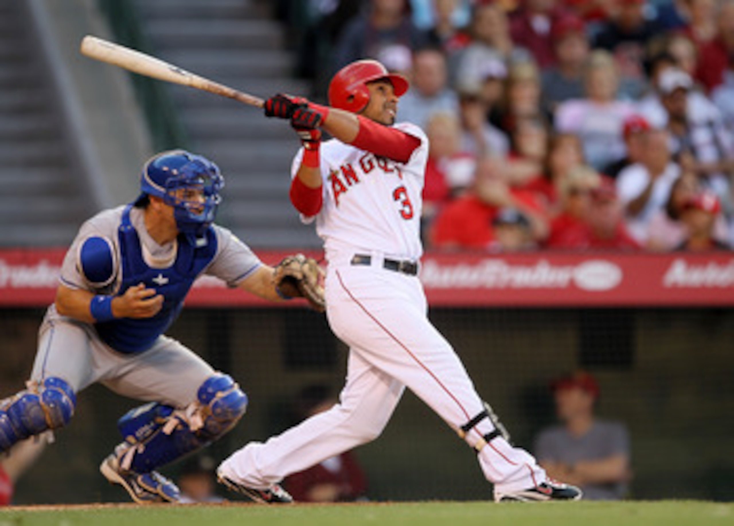 ANAHEIM, CA - JUNE 11:  Maicer Izturis #13 of the Los Angeles Angels of Anaheim hits a sacrifice fly to score Erick Aybar in the second inning against the Kansas City Royals on June 11, 2011 at Angel Stadium in Anaheim, California.  (Photo by Stephen Dunn