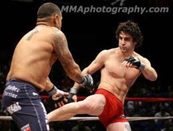 Charlie Brenneman landing a solid leg kick