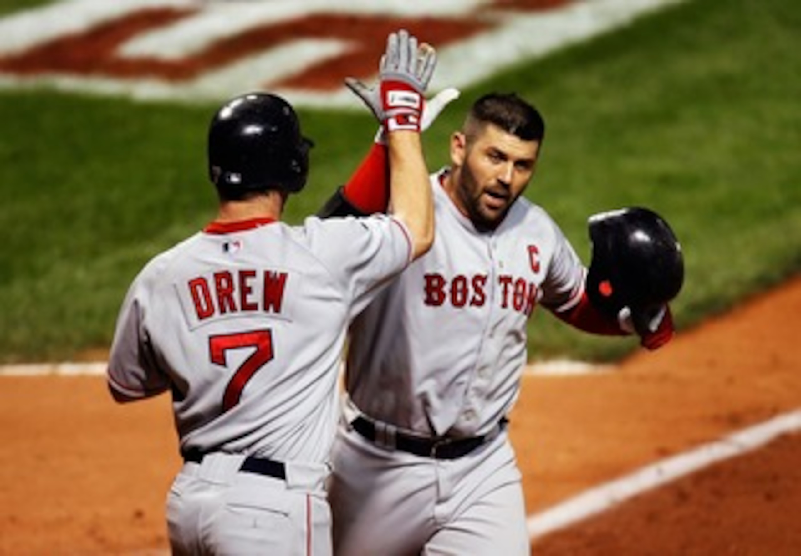 CLEVELAND - OCTOBER 15: Jason Varitek #33 of the Boston Red Sox celebrates with J.D. Drew #7 after scoring him with a two-run home run in the seventh inning against the Cleveland Indians during Game Three of the American League Championship Series at Jac CLEVELAND - OCTOBER 15: Jason Varitek #33 of the Boston Red Sox celebrates with J.D. Drew #7 after scoring him with a two-run home run in the seventh inning against the Cleveland Indians during Game Three of the American League Championship Series at Jac