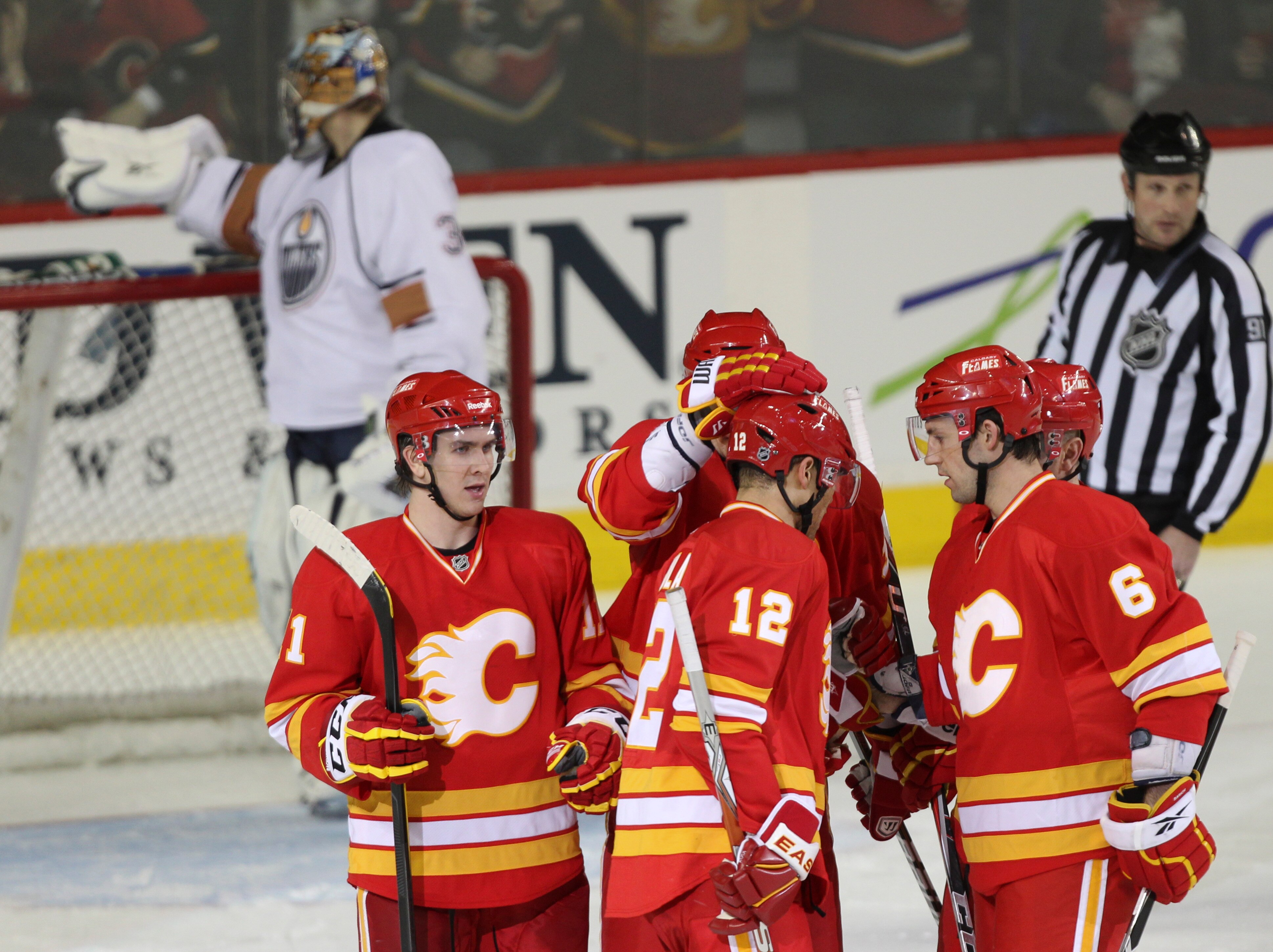 CALGARY, CANADA - APRIL 6: Jarome Iginla #12 of the Calgary Flames is congratulated by teammates Mikael Backlund #11 and Cory Sarich #6 after scoring his 40th goal against Nikolai Khabibulin #35 of the Edmonton Oilers in second period NHL action on April