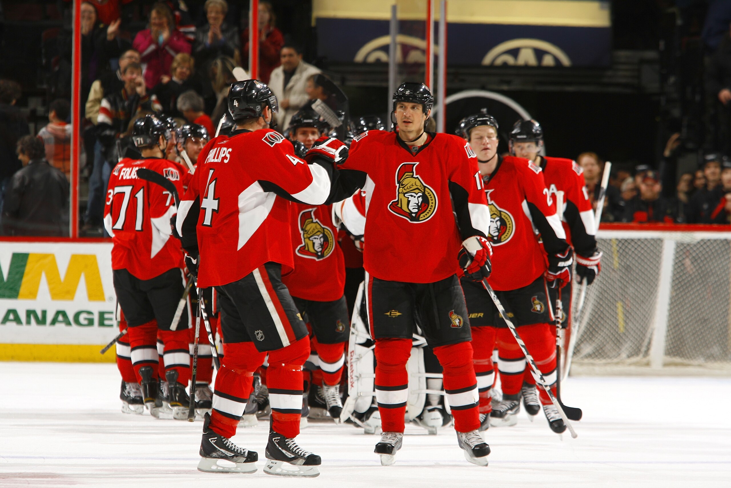 OTTAWA, CANADA - APRIL 07:  Chris Phillips #4 of the Ottawa Senators high-fives teammate Filip Kuba #17 after a victory over the Montreal Canadiens at Scotiabank Place on April 7, 2011 in Ottawa, Canada.  (Photo by Phillip MacCallum/Getty Images)