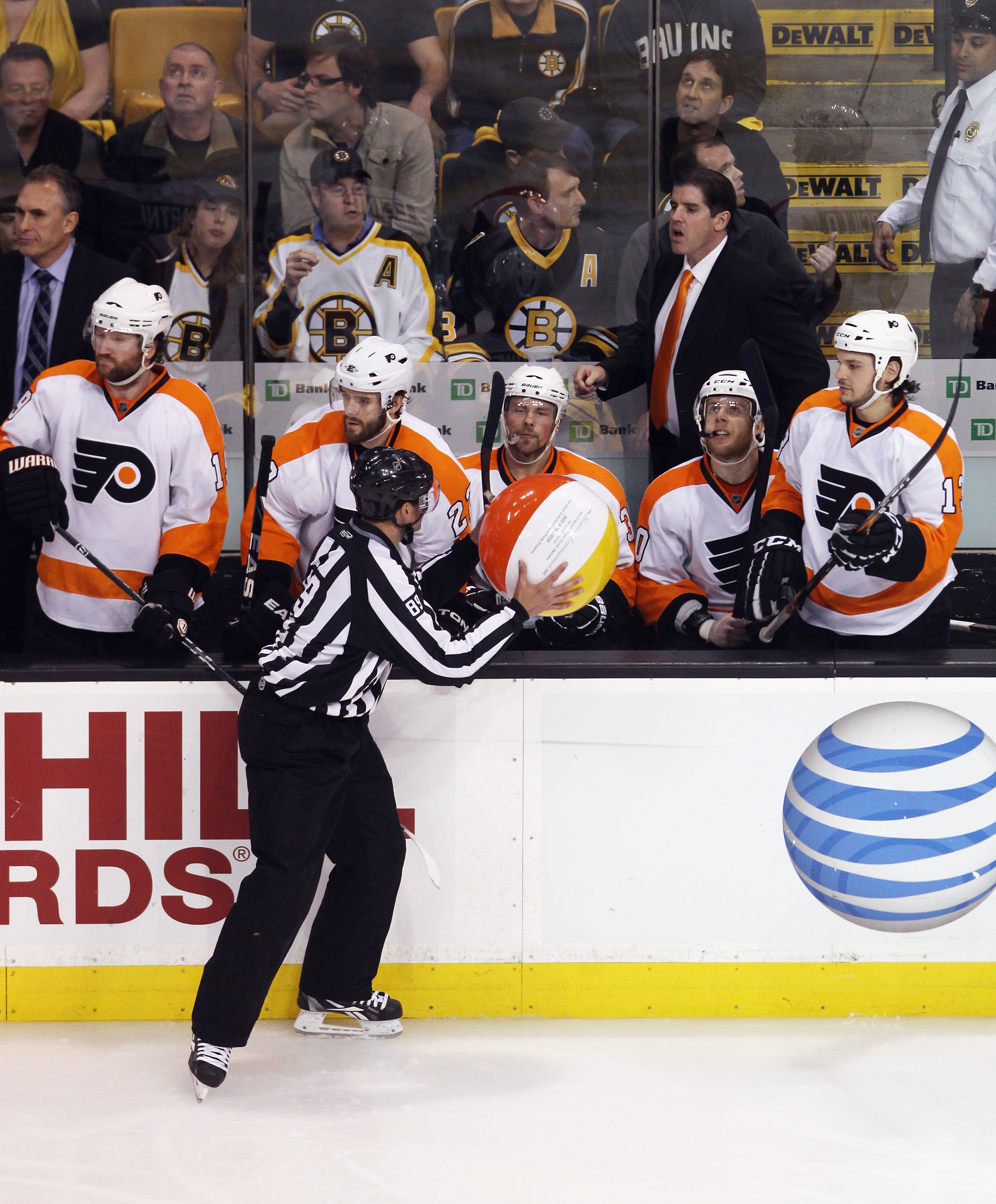 BOSTON, MA - MAY 06: Linesman Steve Miller #89  captures a ball that was tossed on the ice in the third period during the game between the Boston Bruins and Philadelphia Flyers in Game Four of the Eastern Conference Semifinals during the 2011 NHL Stanley
