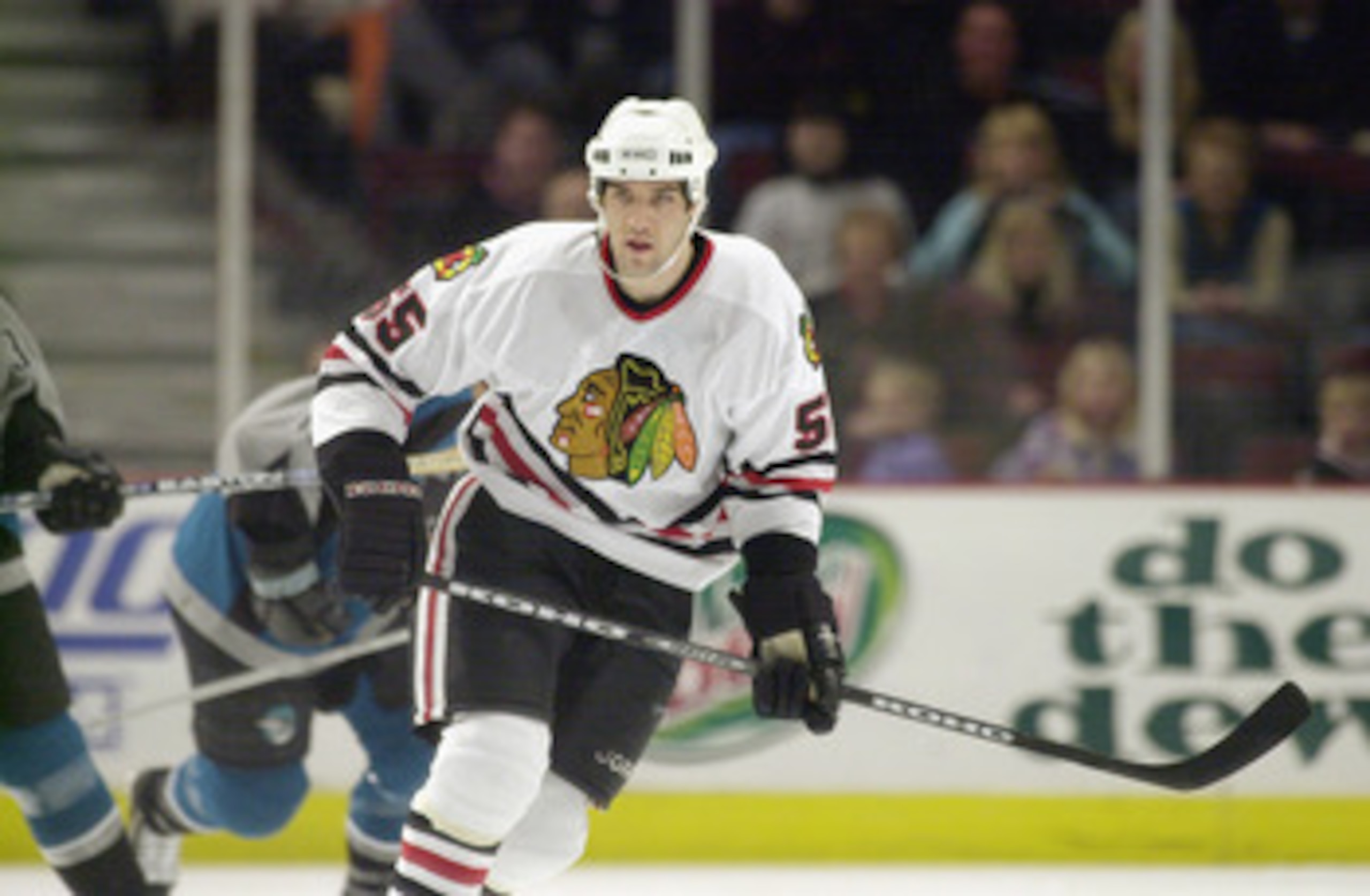 CHICAGO - FEBRUARY 14:  Left wing Eric Daze #55 of the  Chicago Blackhawks skates against the San Jose Sharks on February 14, 2003 at the United Center in Chicago, Illinois.  The Sharks defeated the Blackhawks 4-2.  (Photo by Jonathan Daniel/Getty Images/