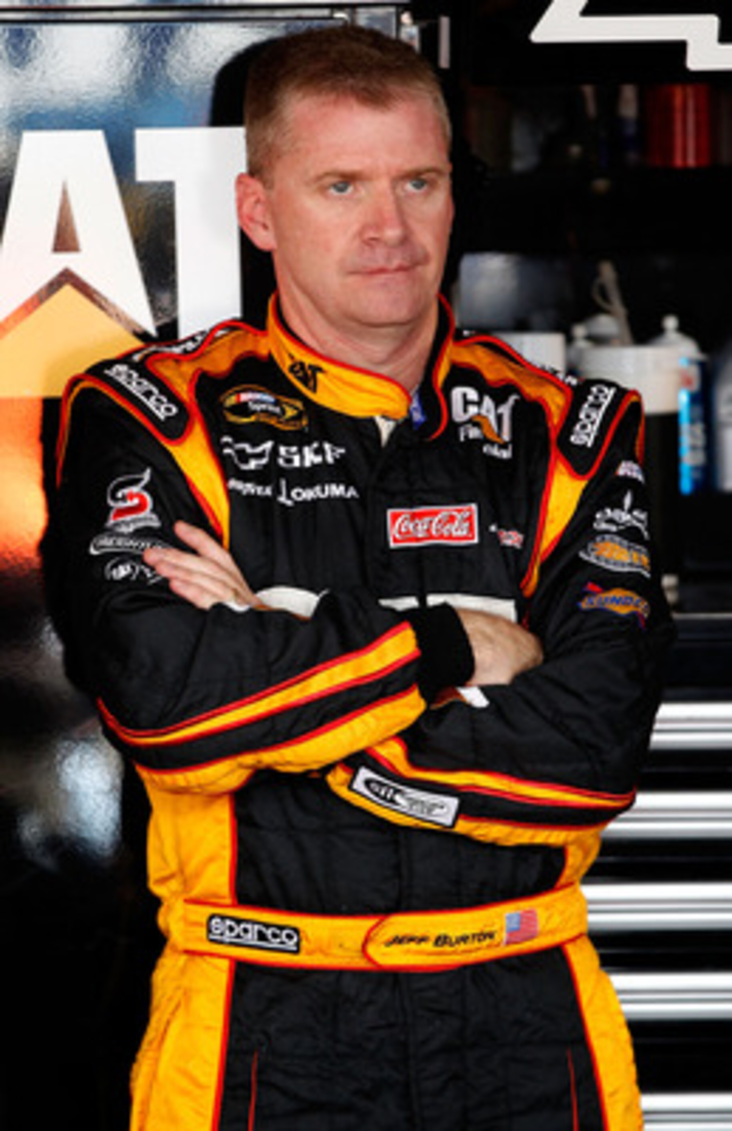 DOVER, DE - MAY 13:  Jeff Burton, driver of the #31 Caterpillar Chevrolet, stands in the garage during practice for the NASCAR Sprint Cup Series FedEx 400 Benefiting Autism Speaks at Dover International Speedway on May 13, 2011 in Dover, Delaware.  (Photo
