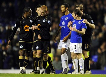 LIVERPOOL, ENGLAND - DECEMBER 11:  Leighton Baines #3 of Everton clashes with Charles N'Zogbia (L) of Wigan Athletic following the Barclays Premier League match between Everton and Wigan Athletic at Goodison Park on December 11, 2010 in Liverpool, England