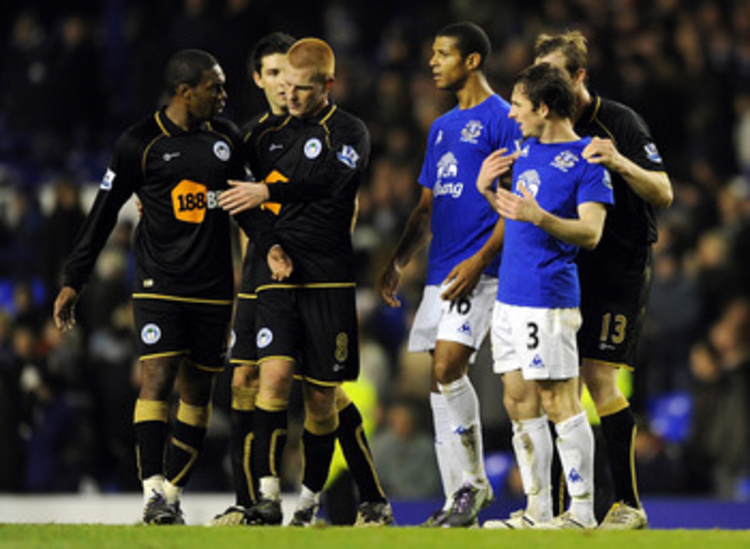 LIVERPOOL, ENGLAND - DECEMBER 11:  Leighton Baines #3 of Everton clashes with Charles N'Zogbia (L) of Wigan Athletic following the Barclays Premier League match between Everton and Wigan Athletic at Goodison Park on December 11, 2010 in Liverpool, England