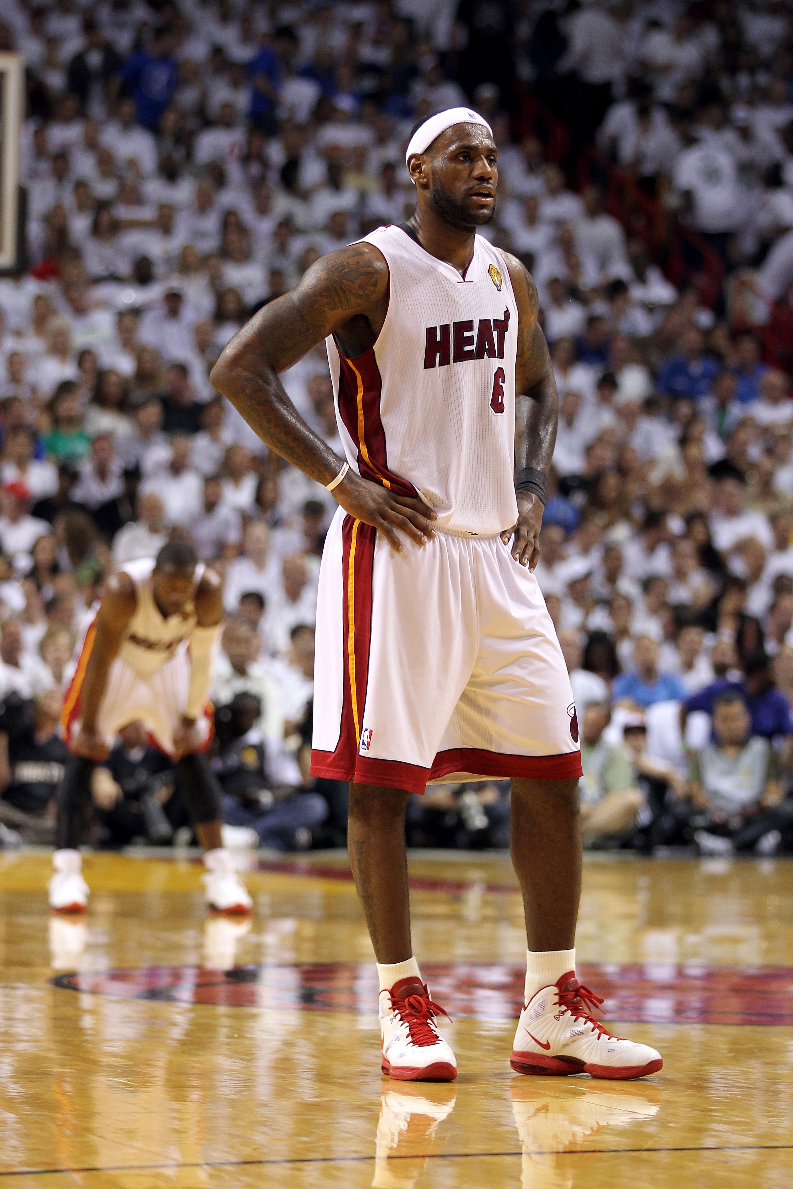 MIAMI, FL - JUNE 12:  LeBron James #6 of the Miami Heat looks on as Dwyane Wade stands in the background against the Dallas Mavericks in Game Six of the 2011 NBA Finals at American Airlines Arena on June 12, 2011 in Miami, Florida. NOTE TO USER: User expr