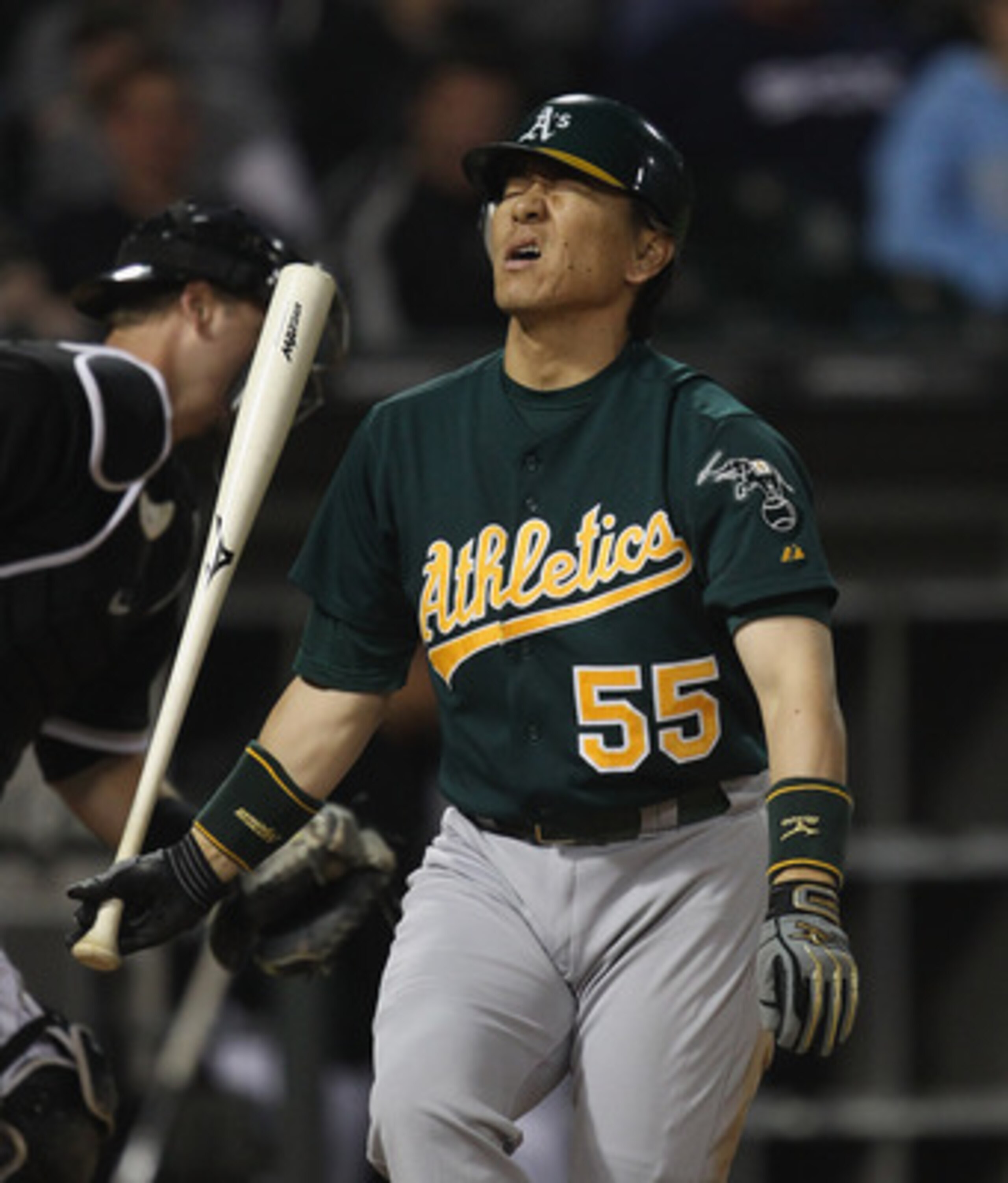 CHICAGO, IL - JUNE 10:  Hideki Matsui #55 of the Oakland Athletics reacts after striking out to end the 7th inning against the Chicago White Sox with teammates at U.S. Cellular Field on June 10, 2011 in Chicago, Illinois. The Athletics defeated the White 